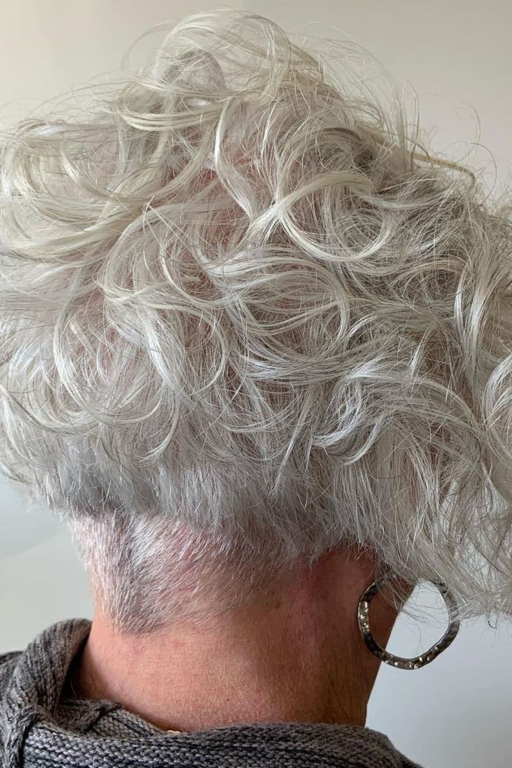 An old woman with a white wedge cut with a nape undercut.