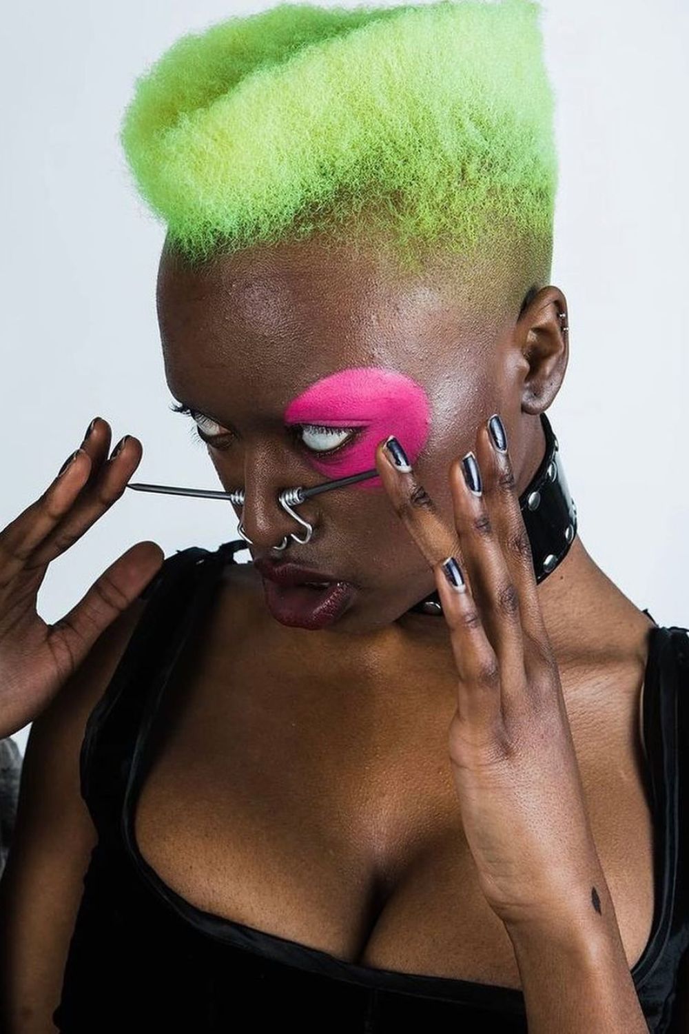 A black woman with a neon faded high top.