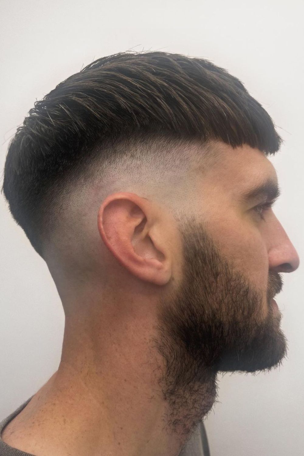 A man with a French crop skin fade.
