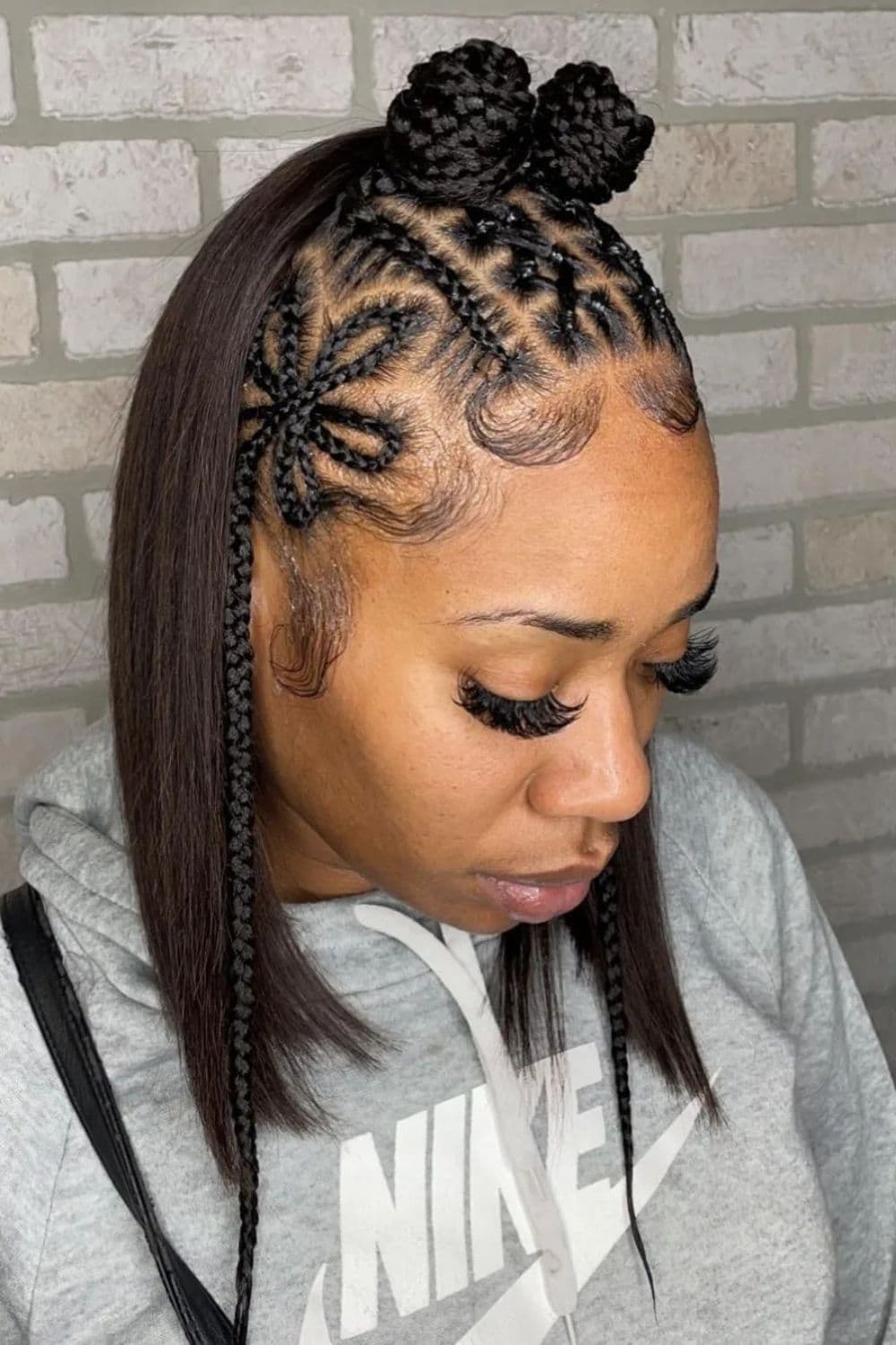 A black woman with a short half-up braid.