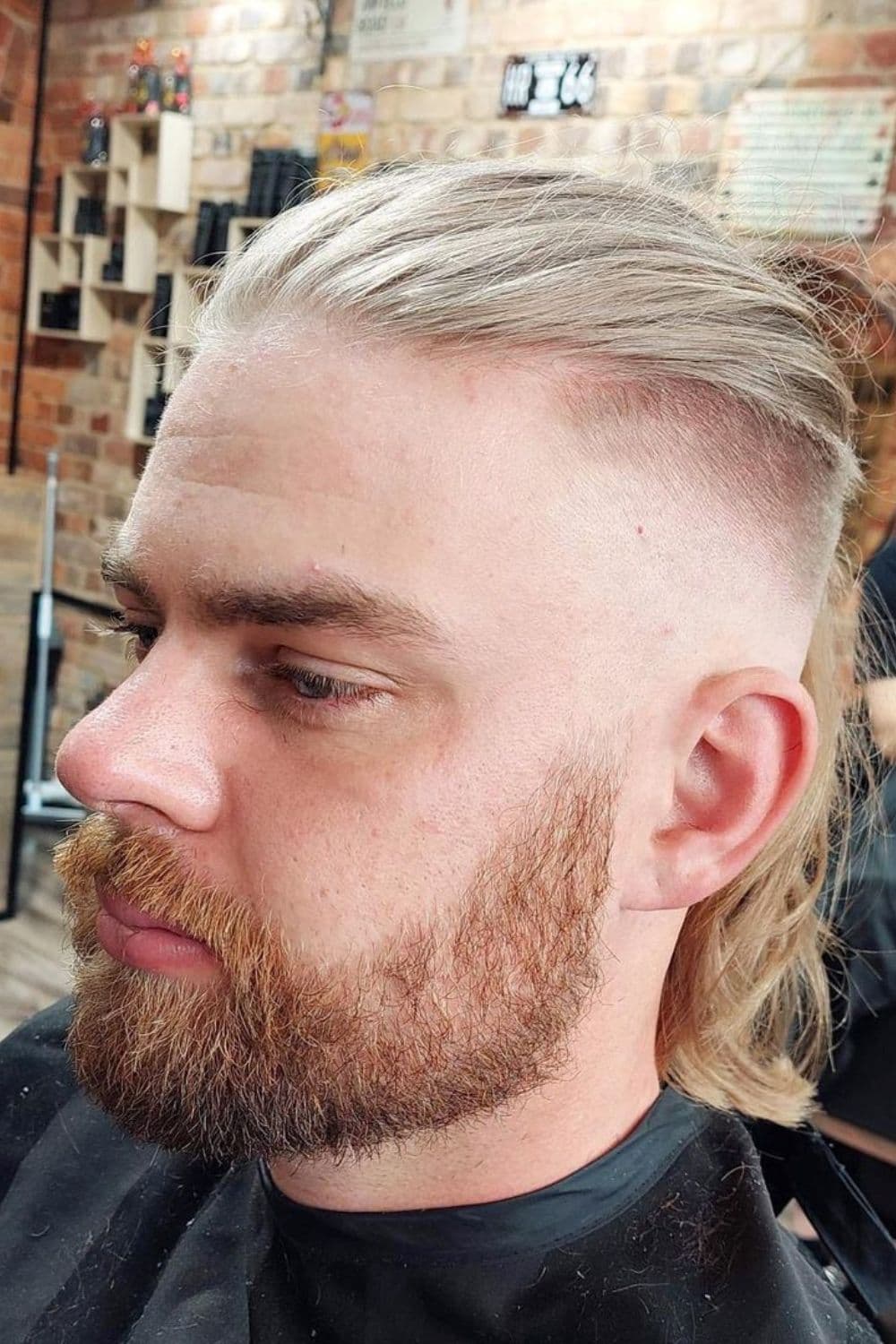 A man with long blonde hair fade.