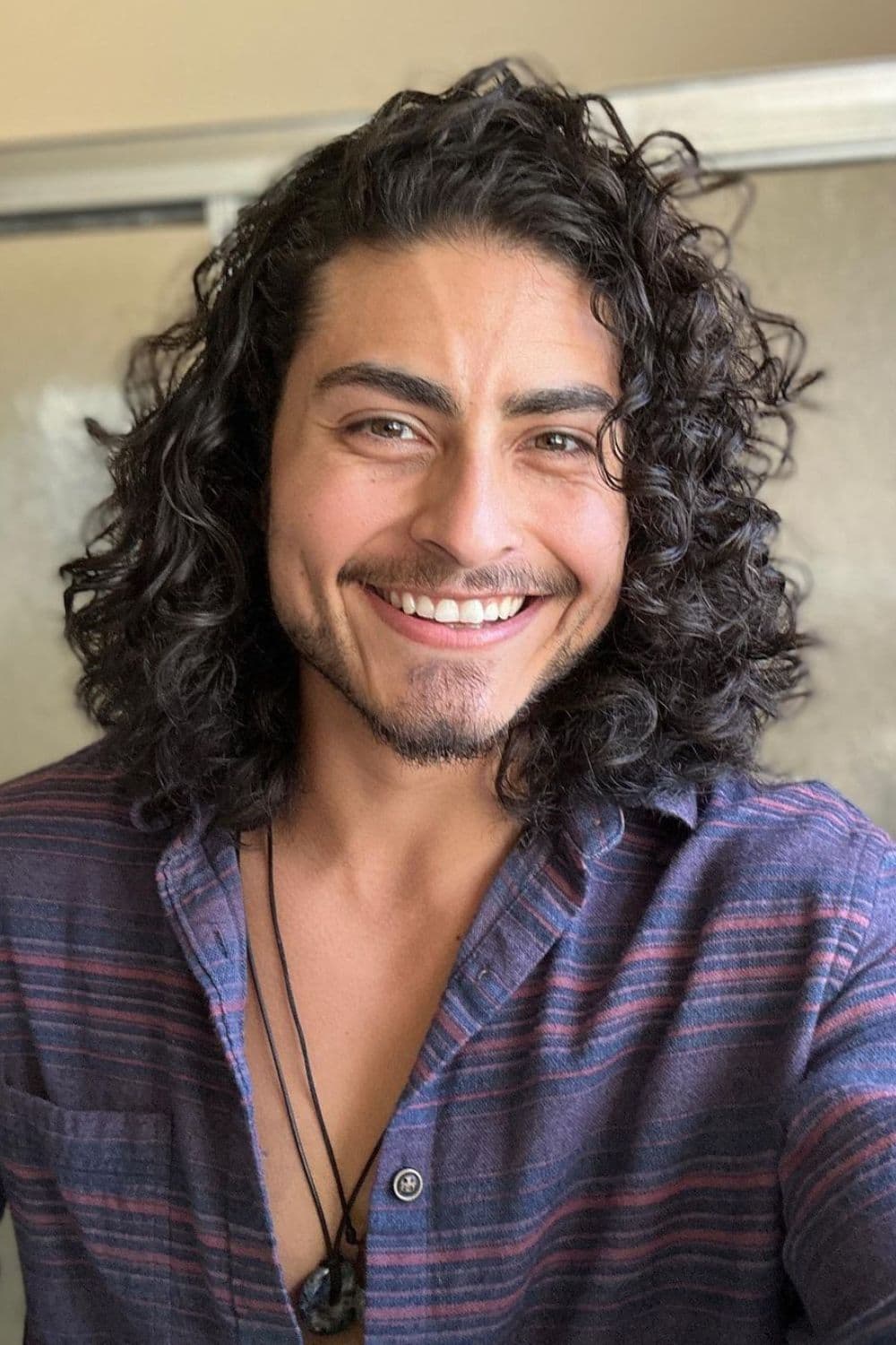A man with long layered curls.