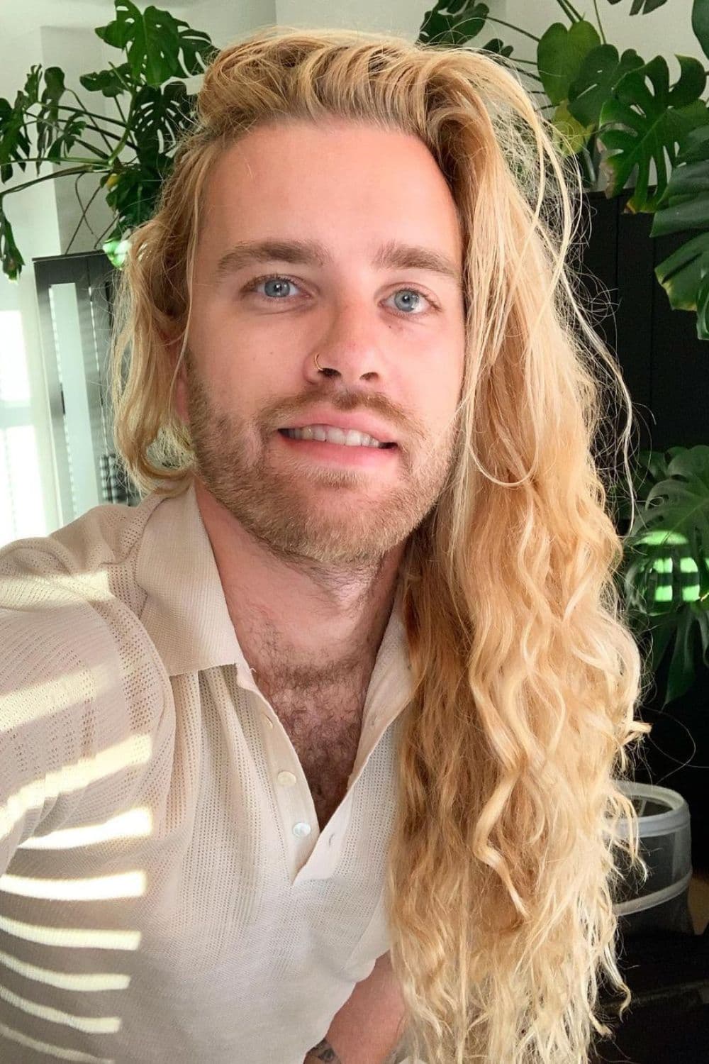 A man with a long blonde wavy hair.