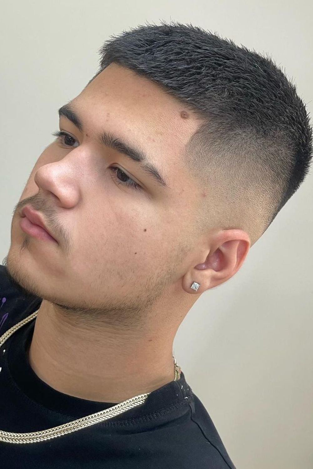 A man with a mid-fade buzz cut.