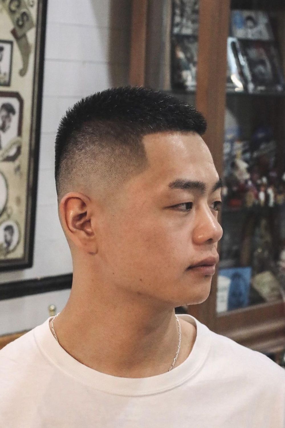 A man with a mid fade crew cut.