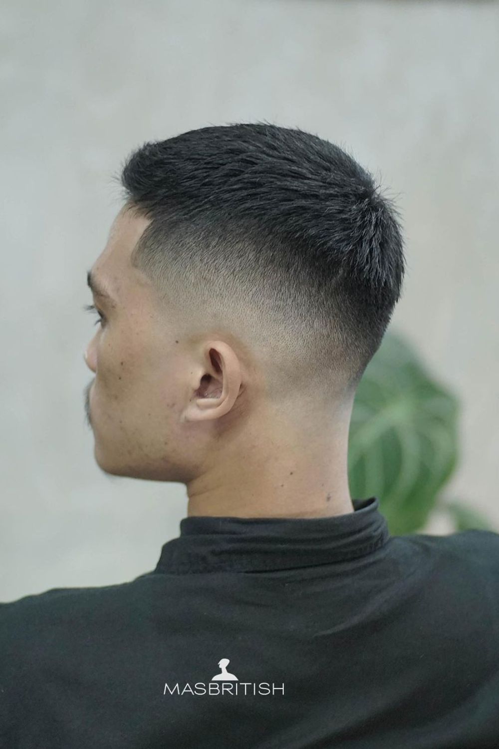 A man with a mid fade crew cut.