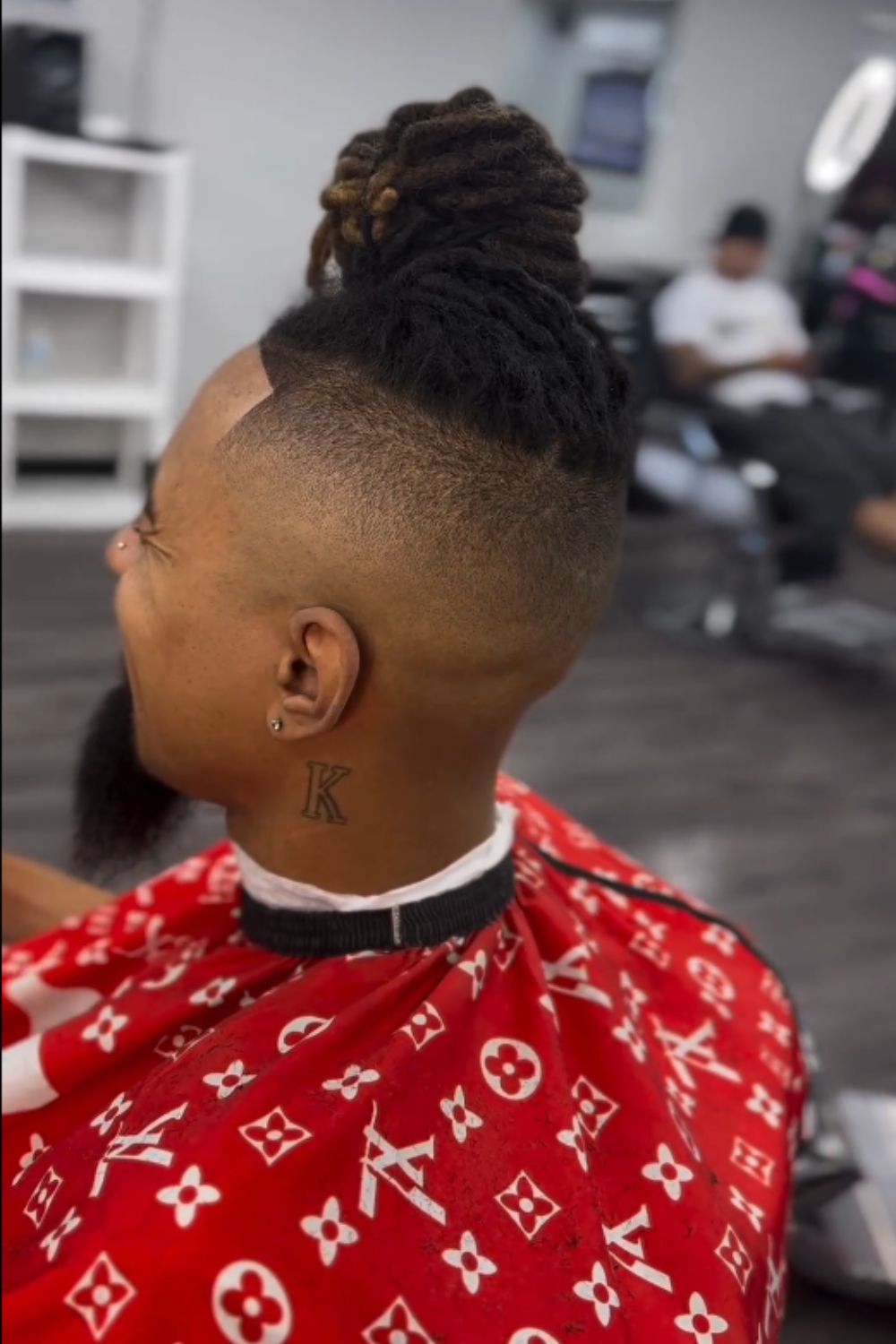 A man with a mid fade dreads.