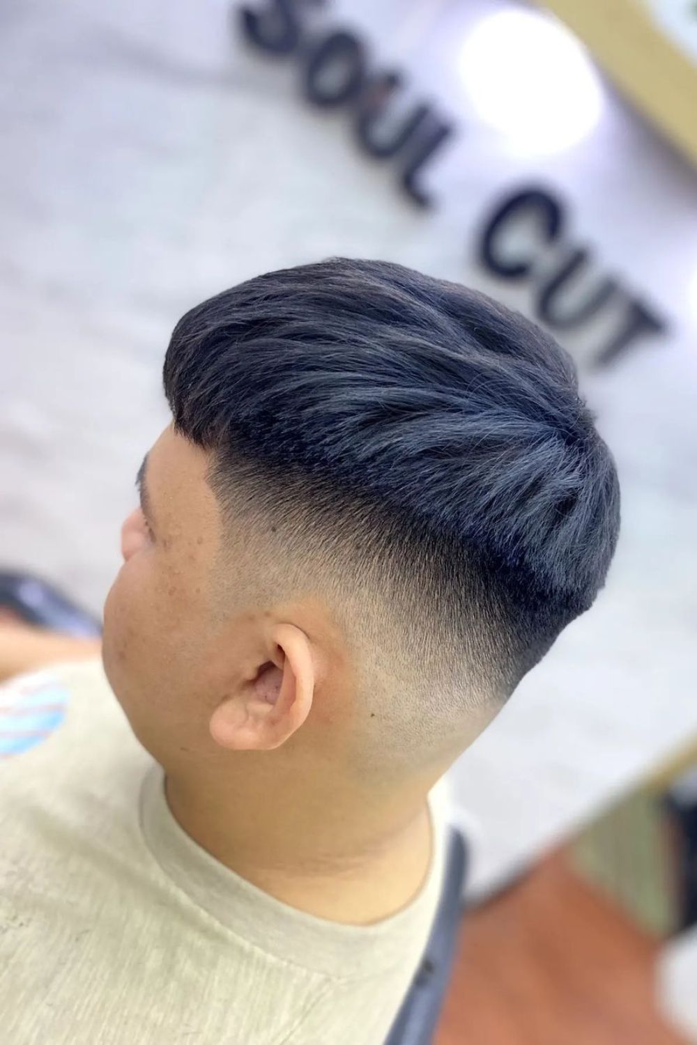 A man with a mid fade French crop.