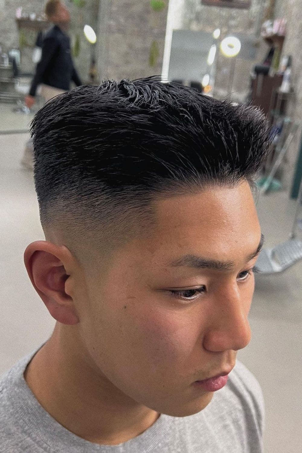 A man with a mid fade ivy league cut.