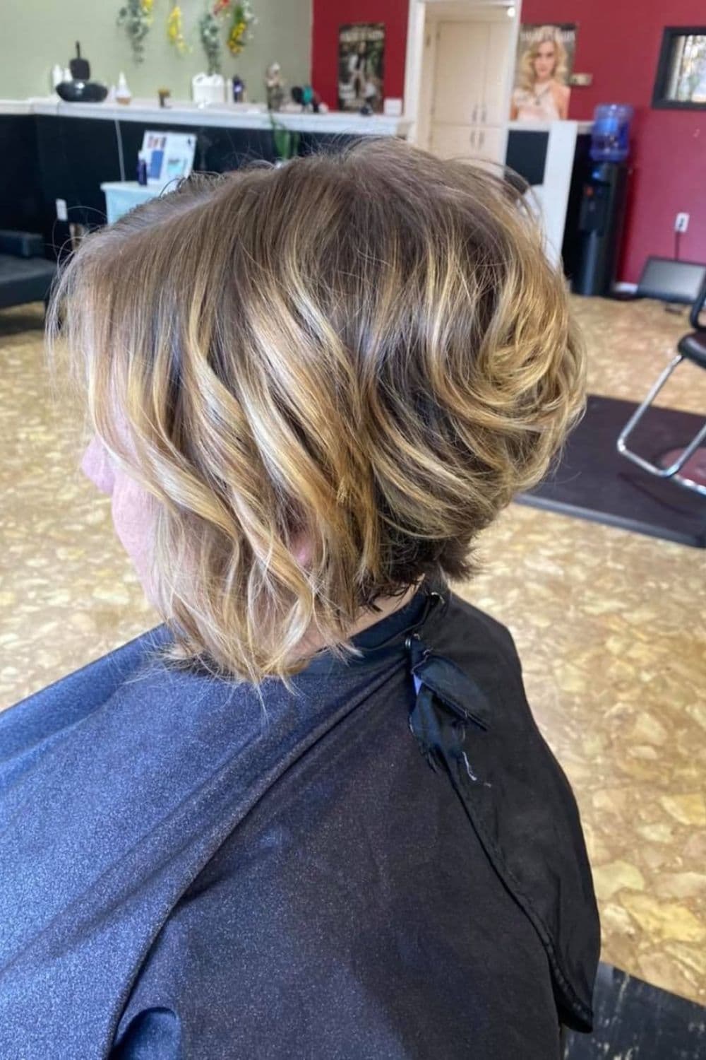 A woman with a stacked curly bob.