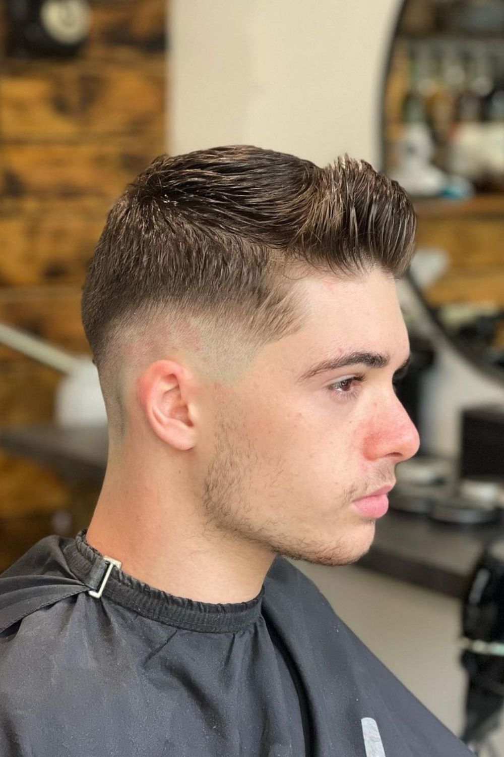 A man with a taper fade crew cut.