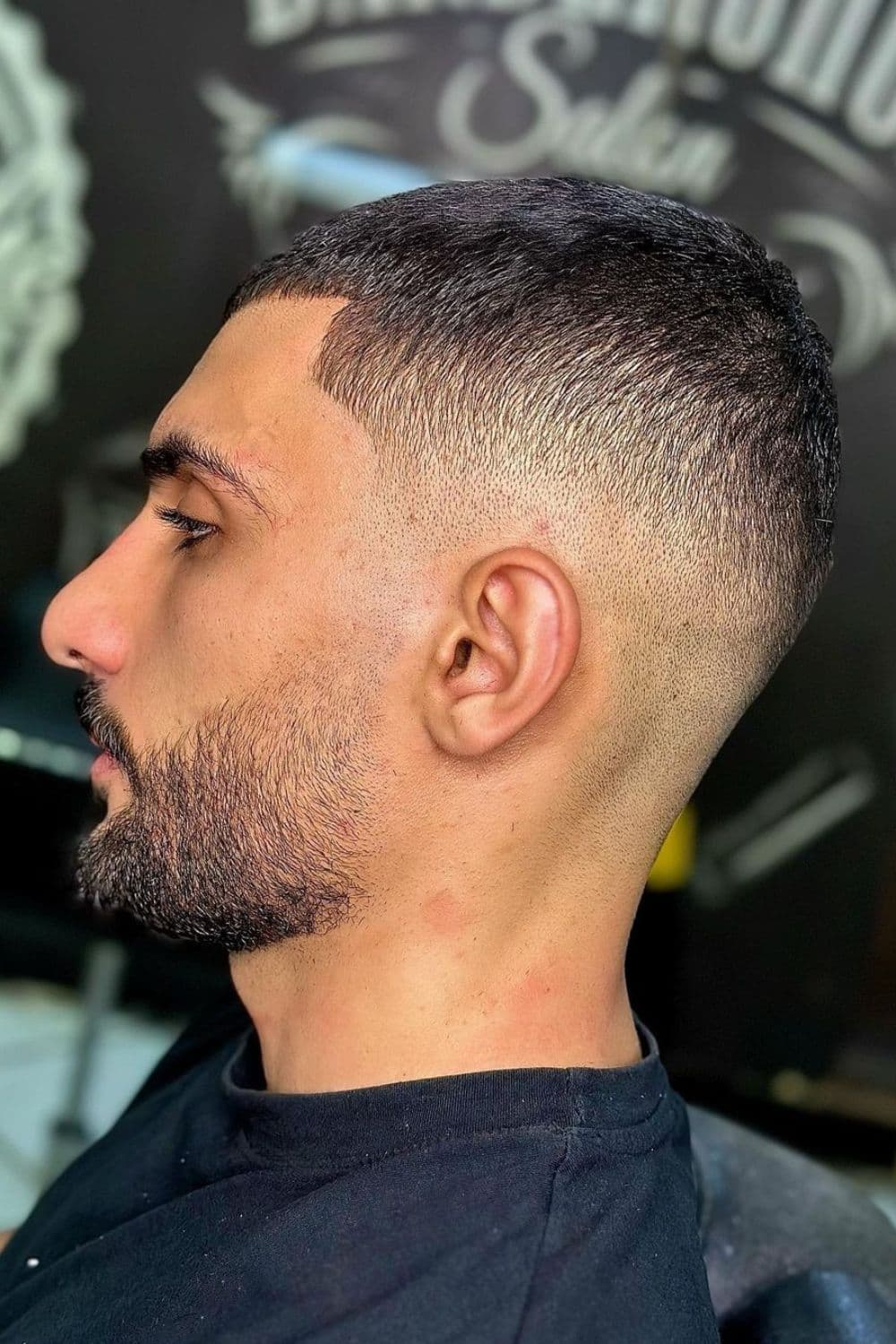 A man with a tapered buzz cut.