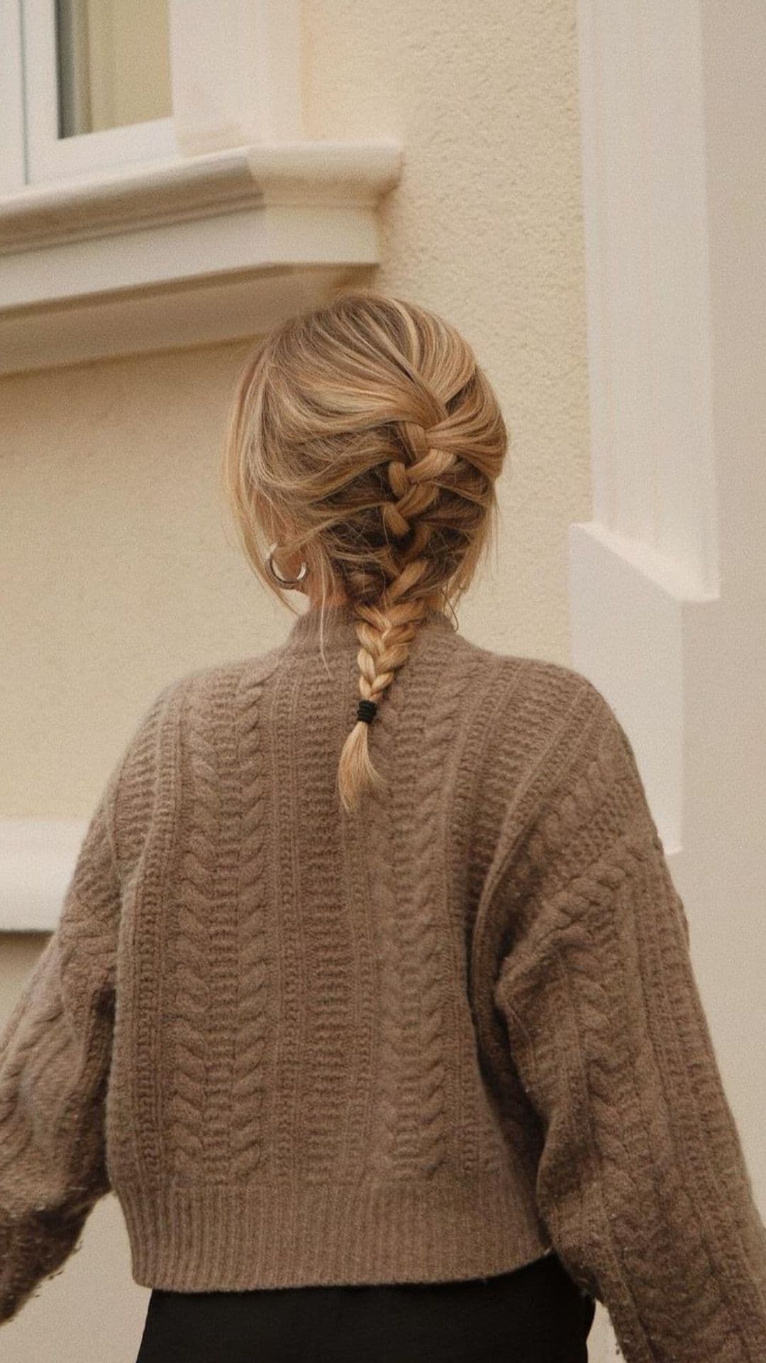 A woman with a blonde fishtail braid.