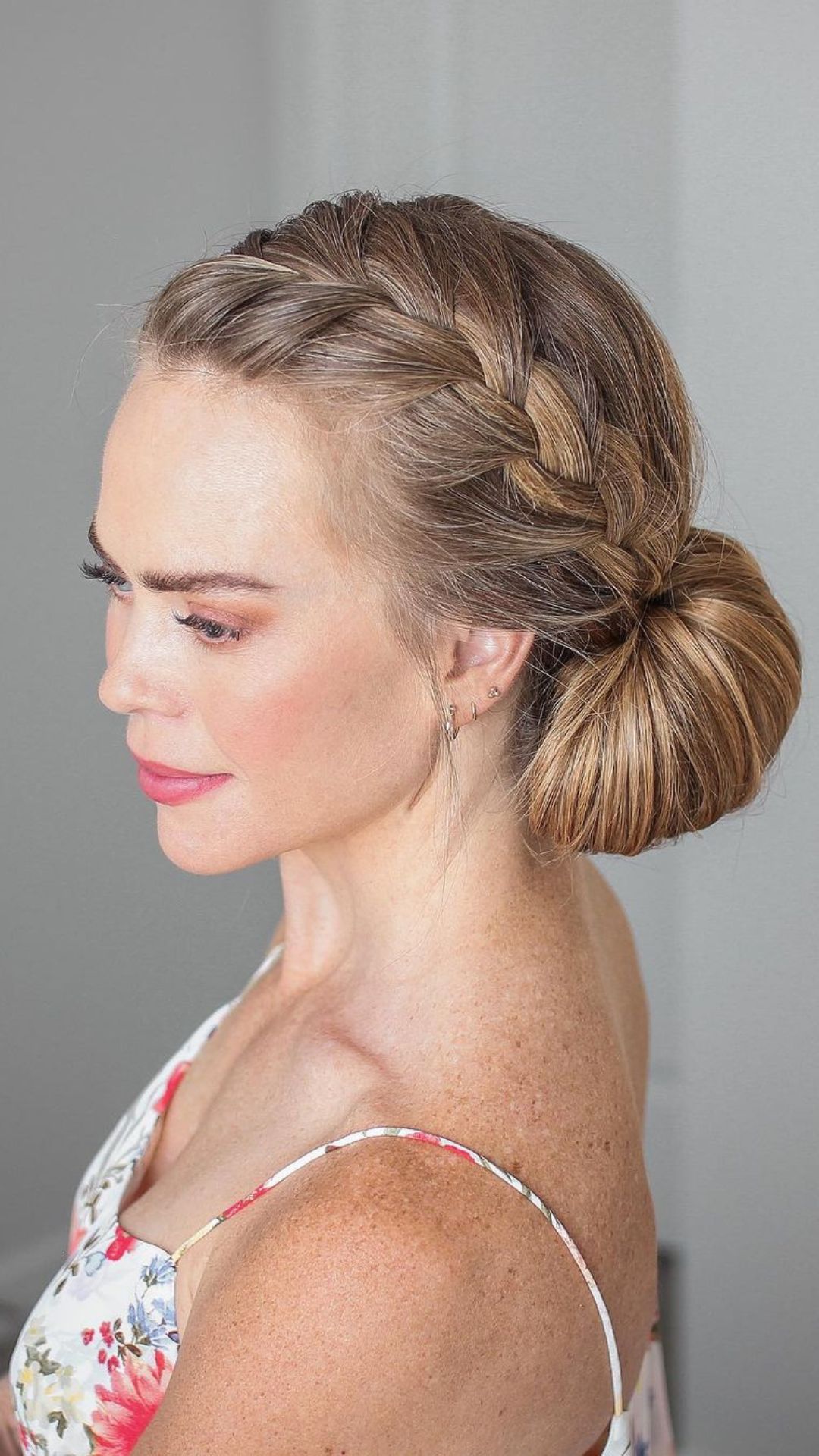 Side view of a woman with a braided updo.