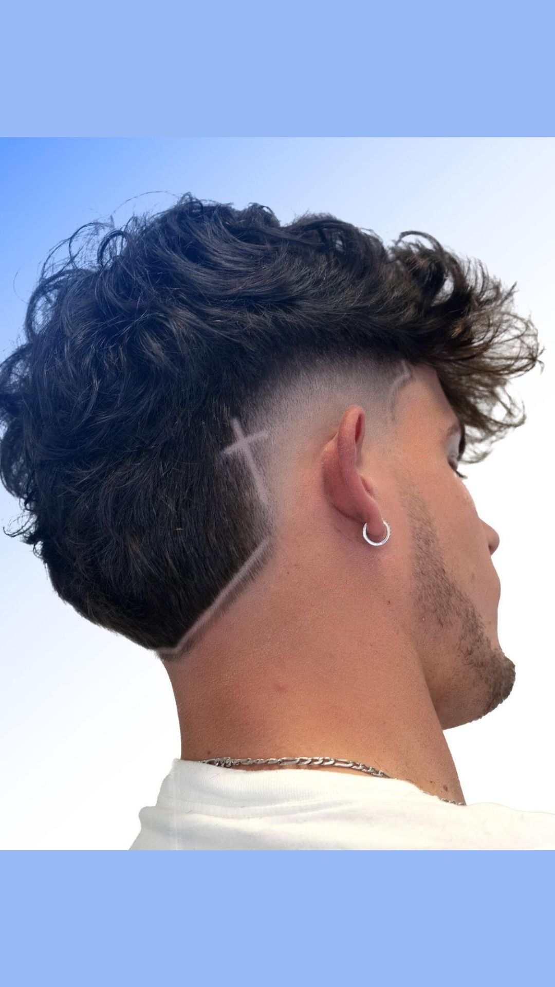 A man with a burst fade and design on hair.