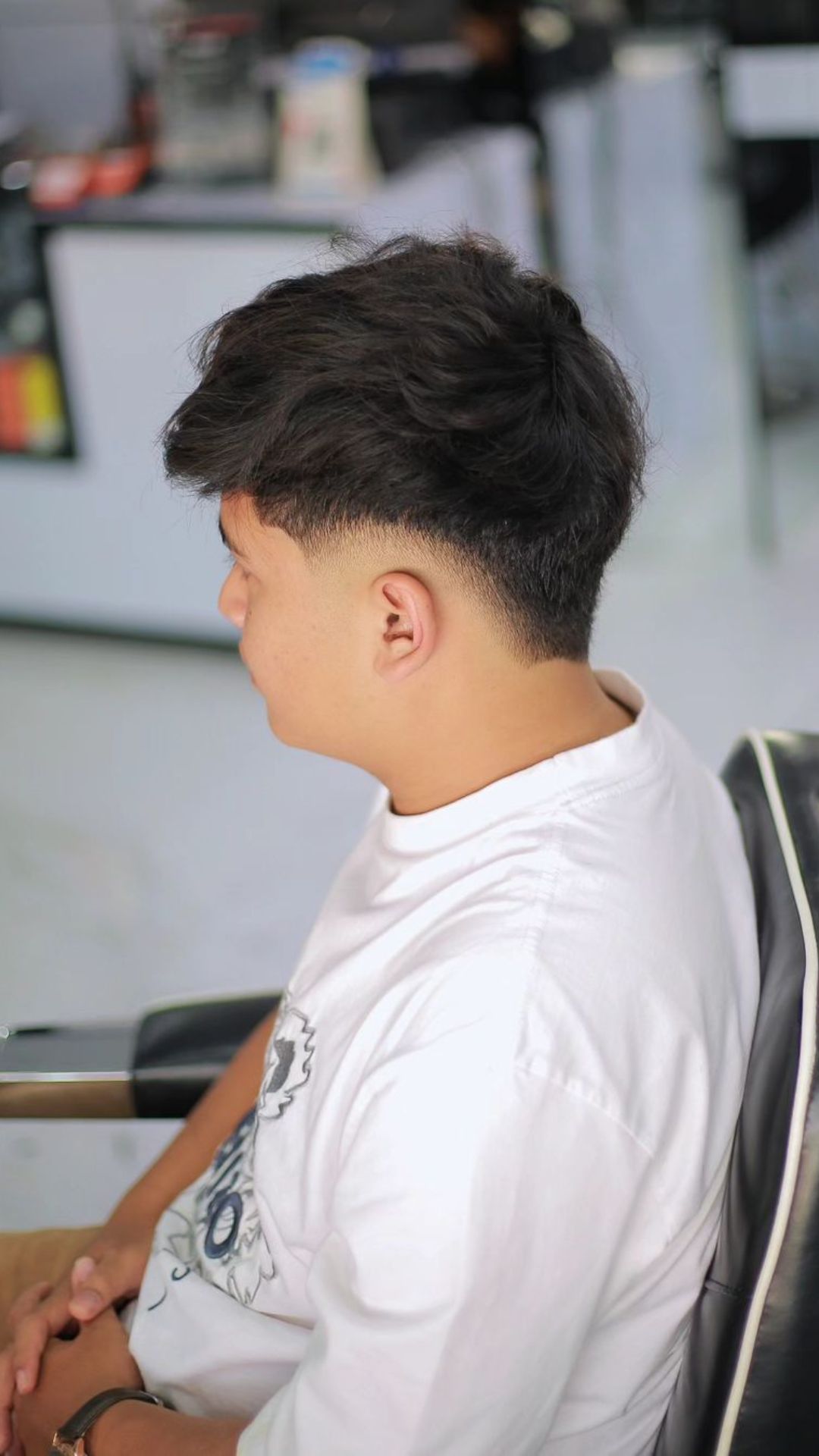 A man with a burst fade and textured fringe.