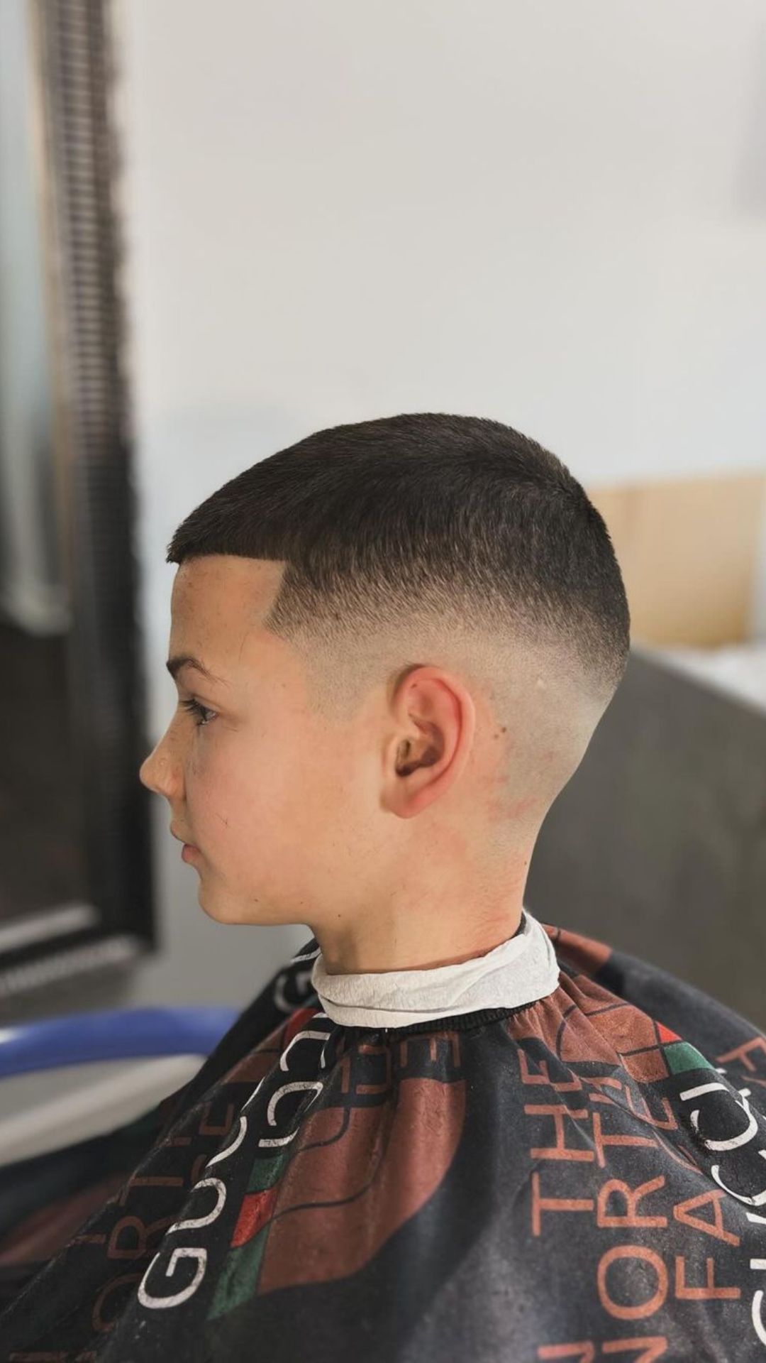 A boy with a buzz cut.