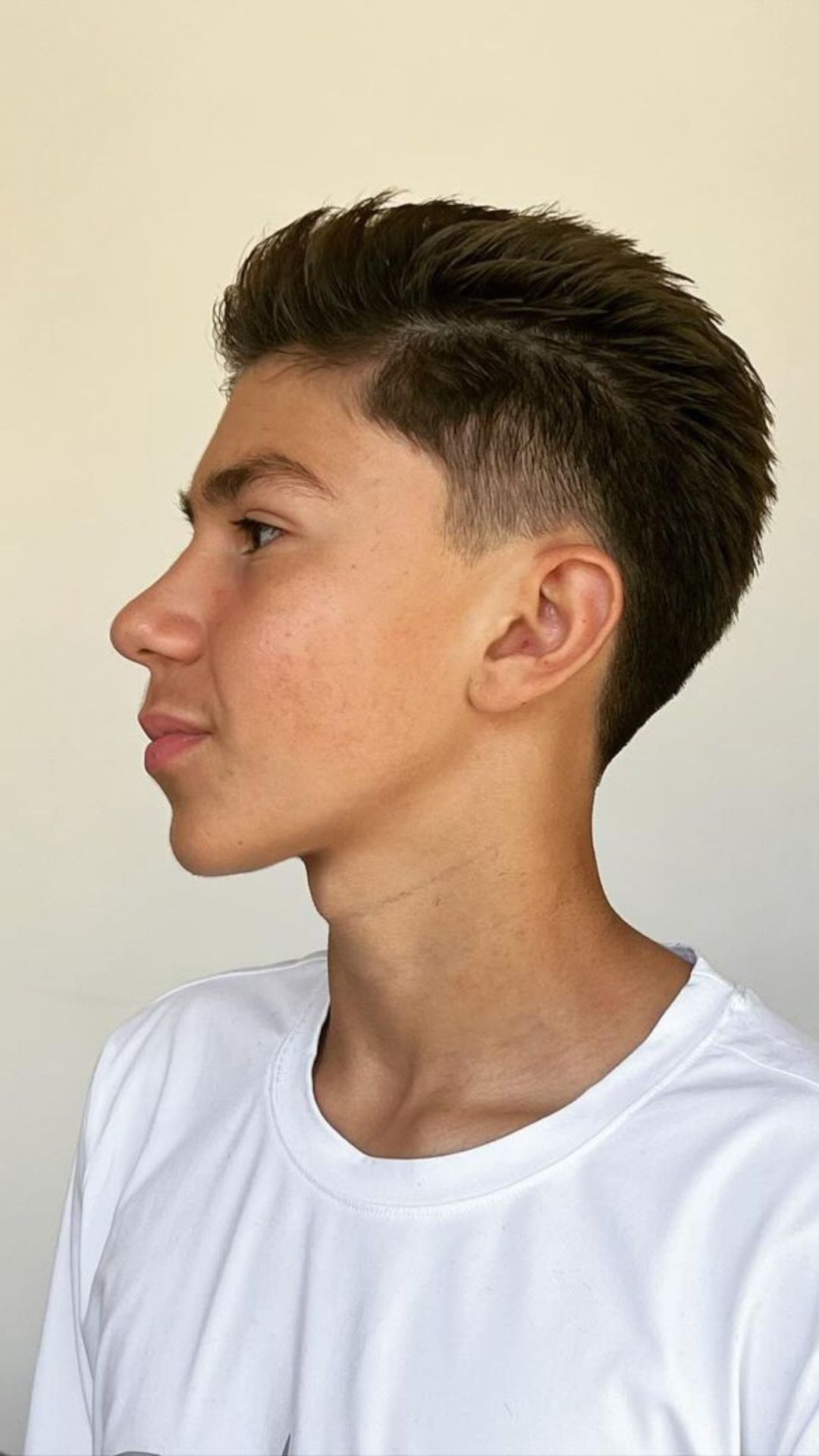 A boy with a classic taper cut.