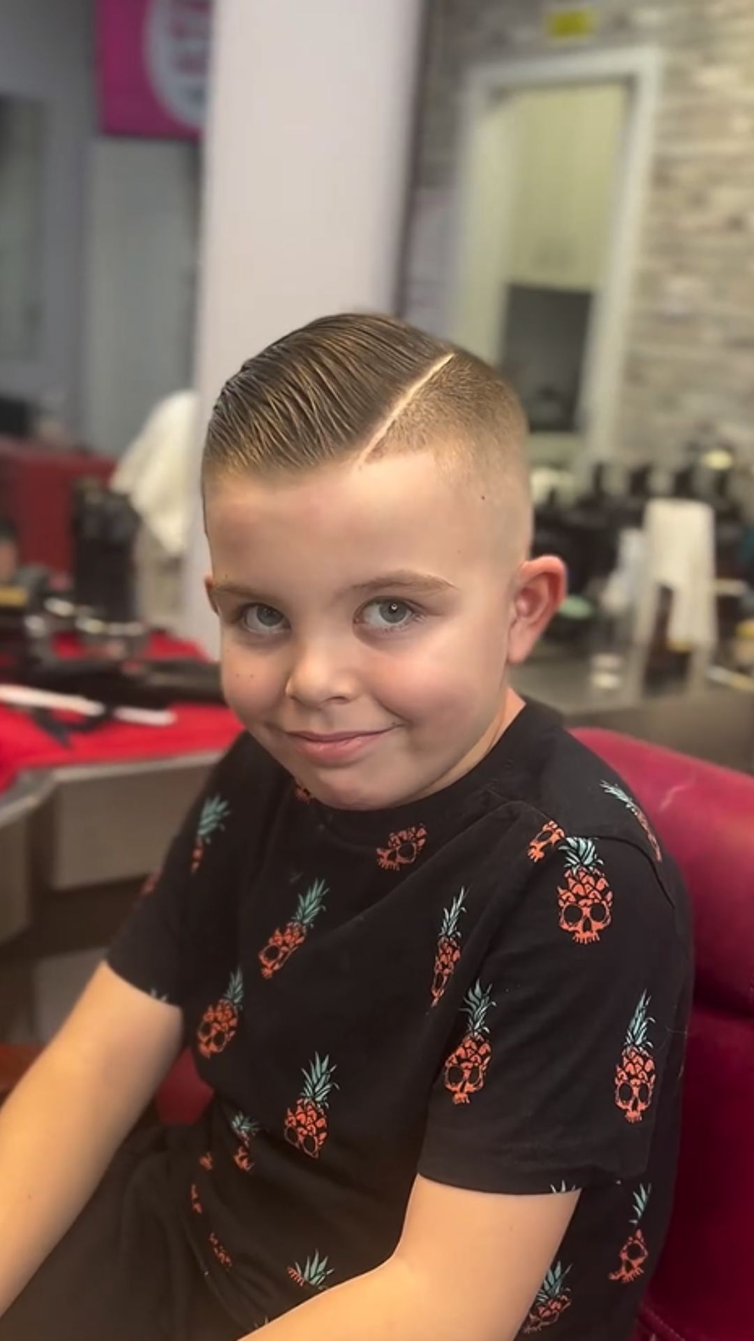 A boy with a comb over cut.