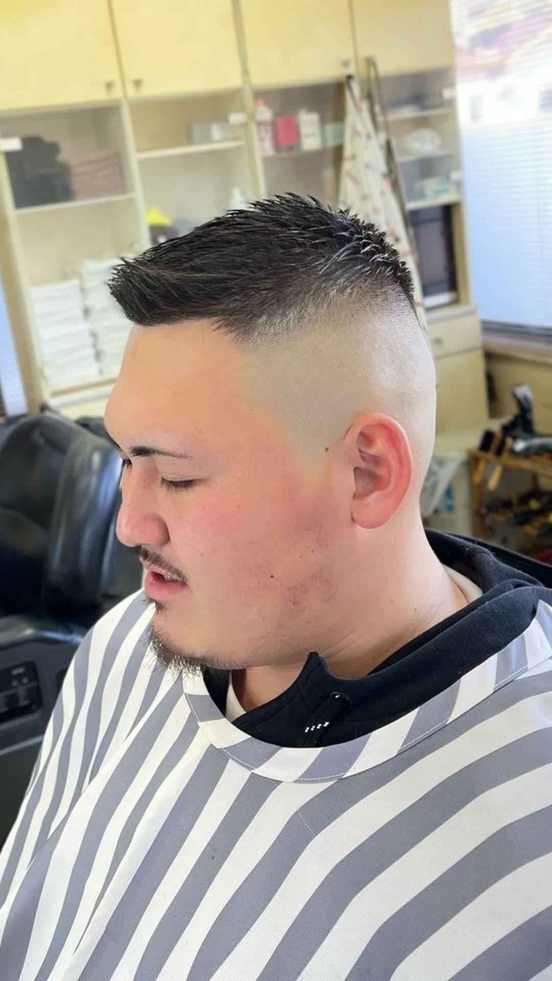 A man with a high skin fade on a crew cut.