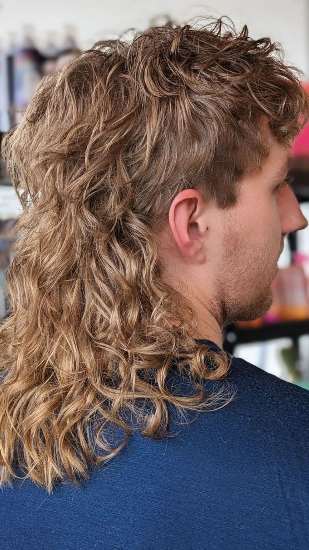 A man with a long curly mullet.