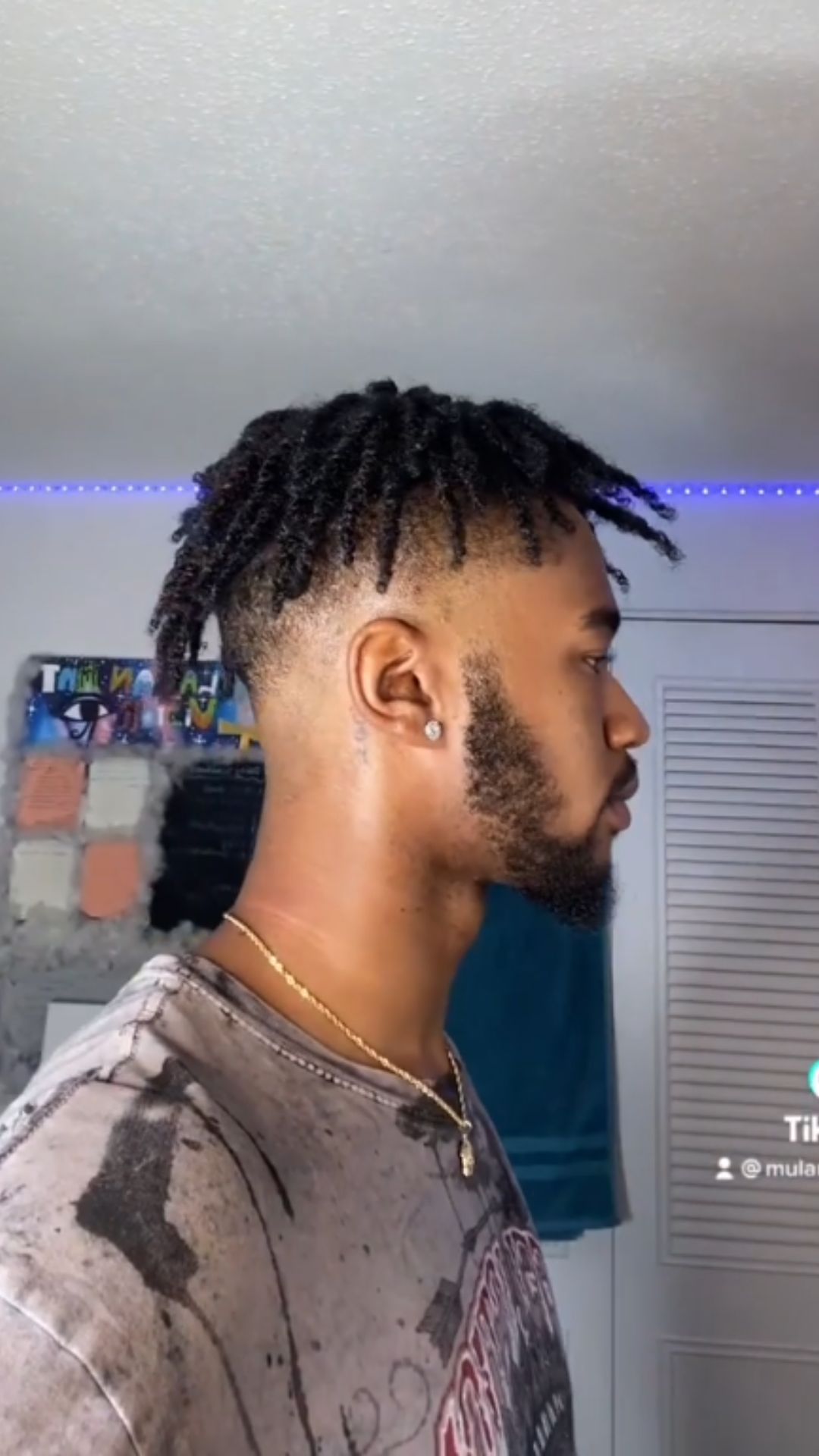A man with a low drop fade and twist hairstyle.