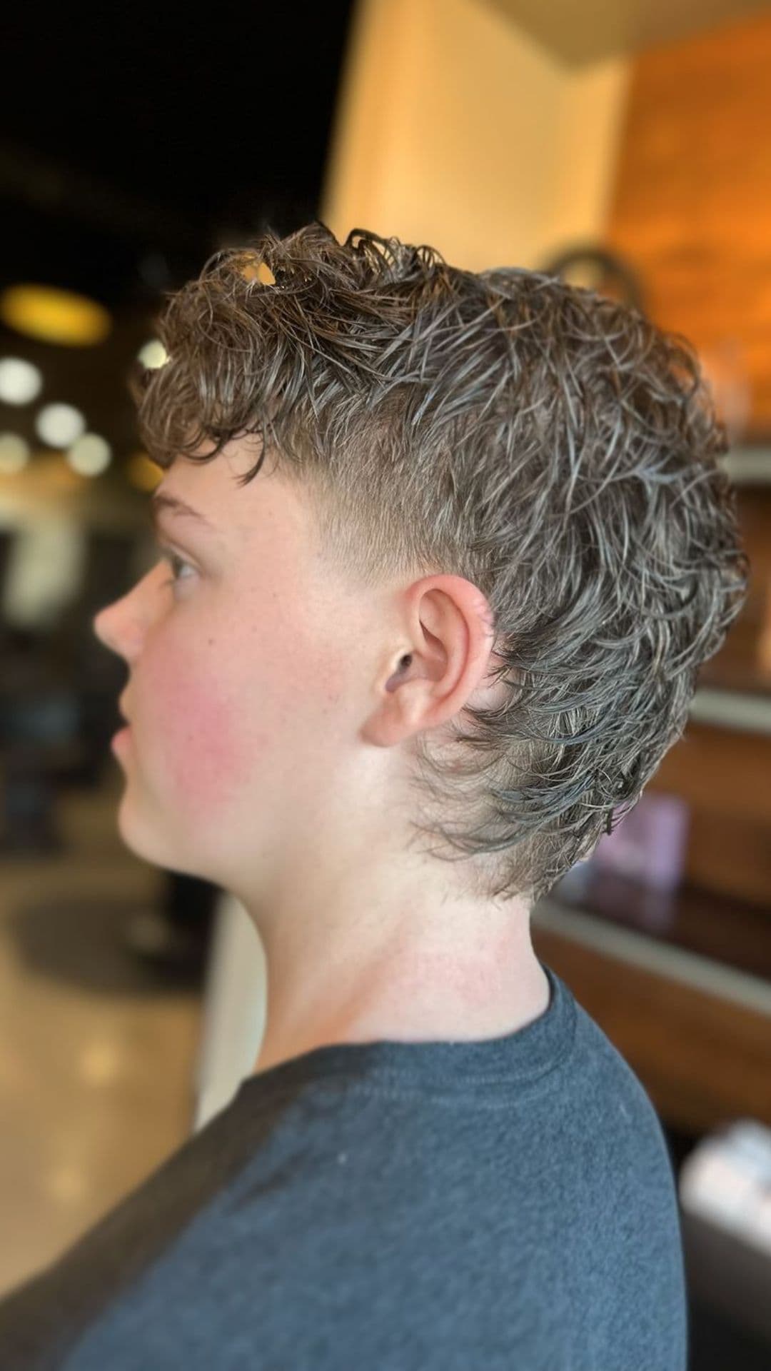 A boy with a modern mullet cut.