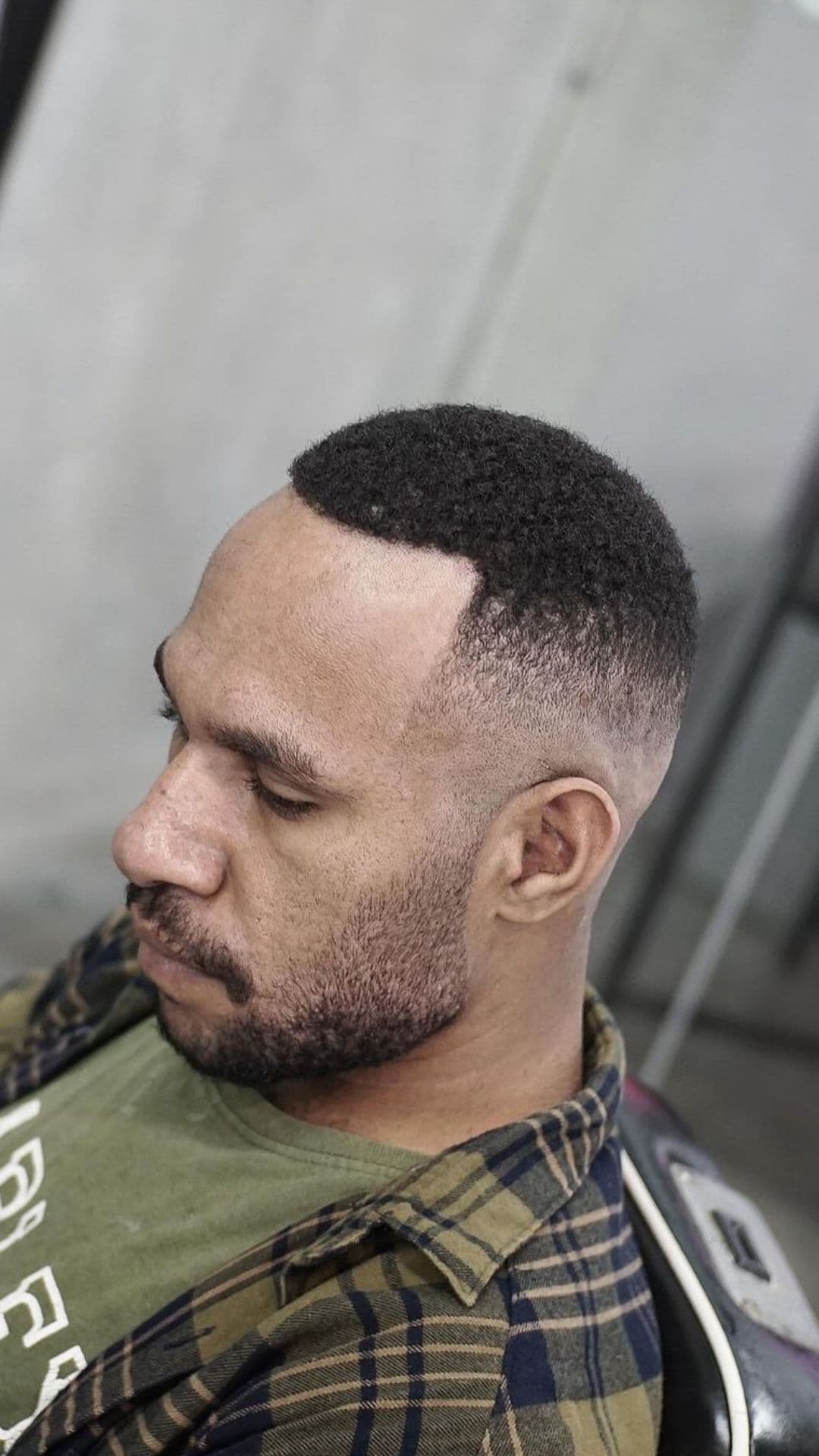A man with a short fade afro hair.