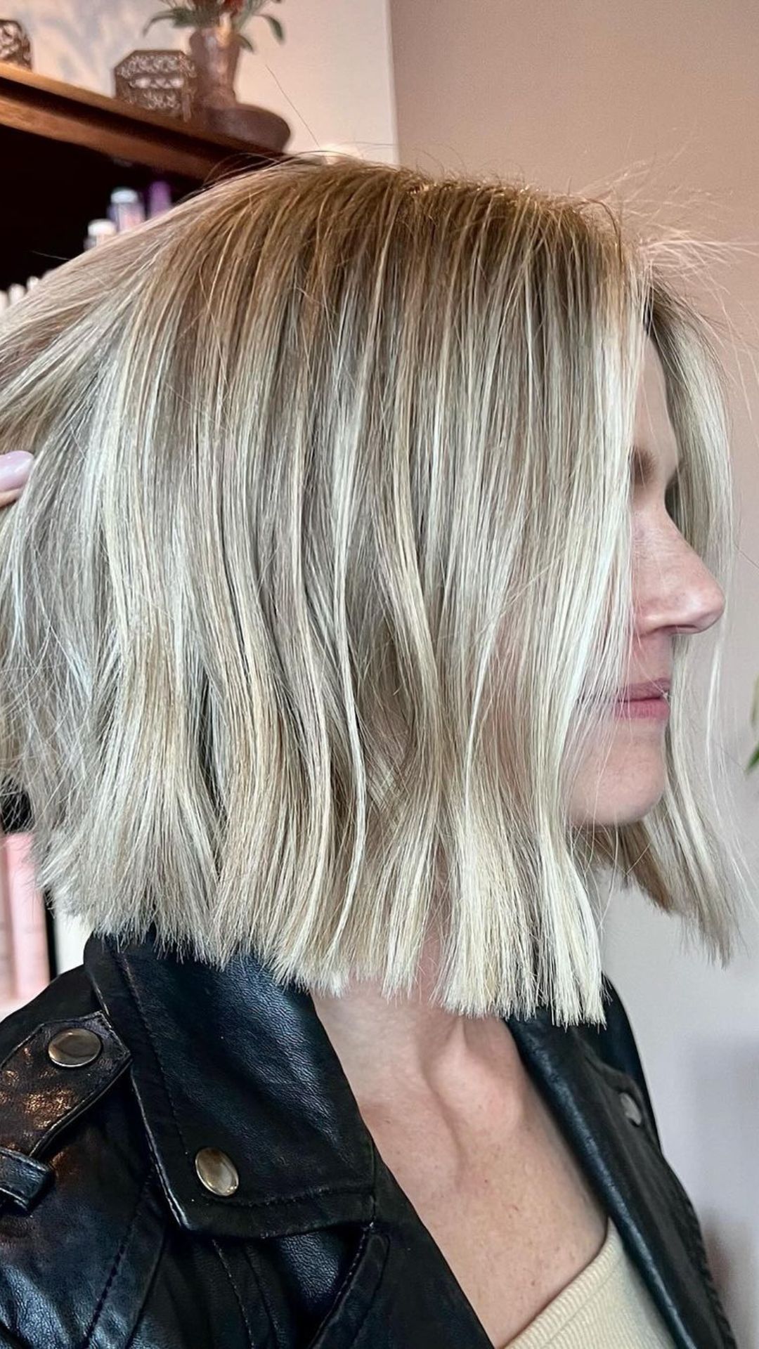 A woman with a short blonde blunt bob.