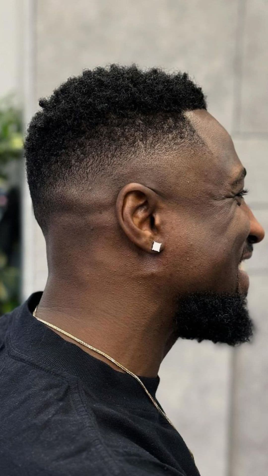 A black man with a short fade haircut.