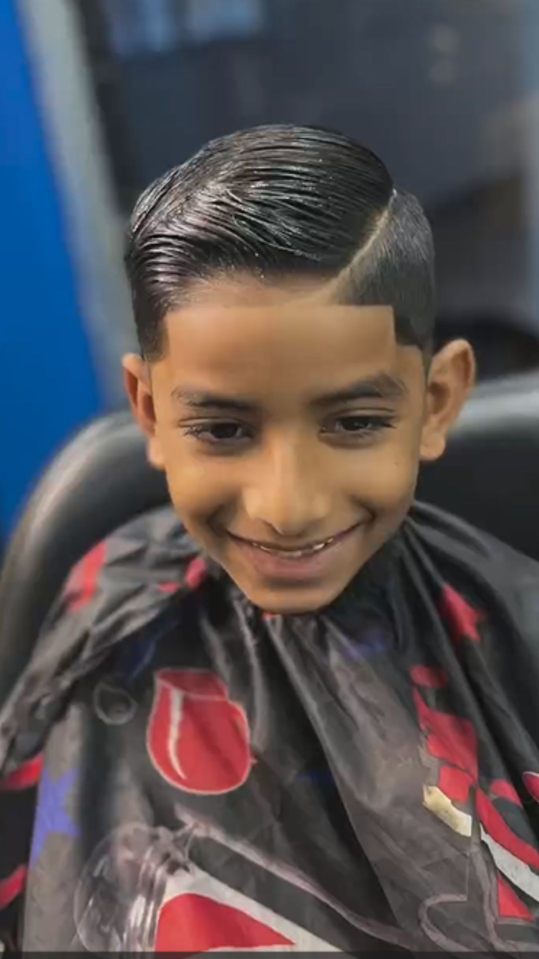 A boy with a side part haircut.