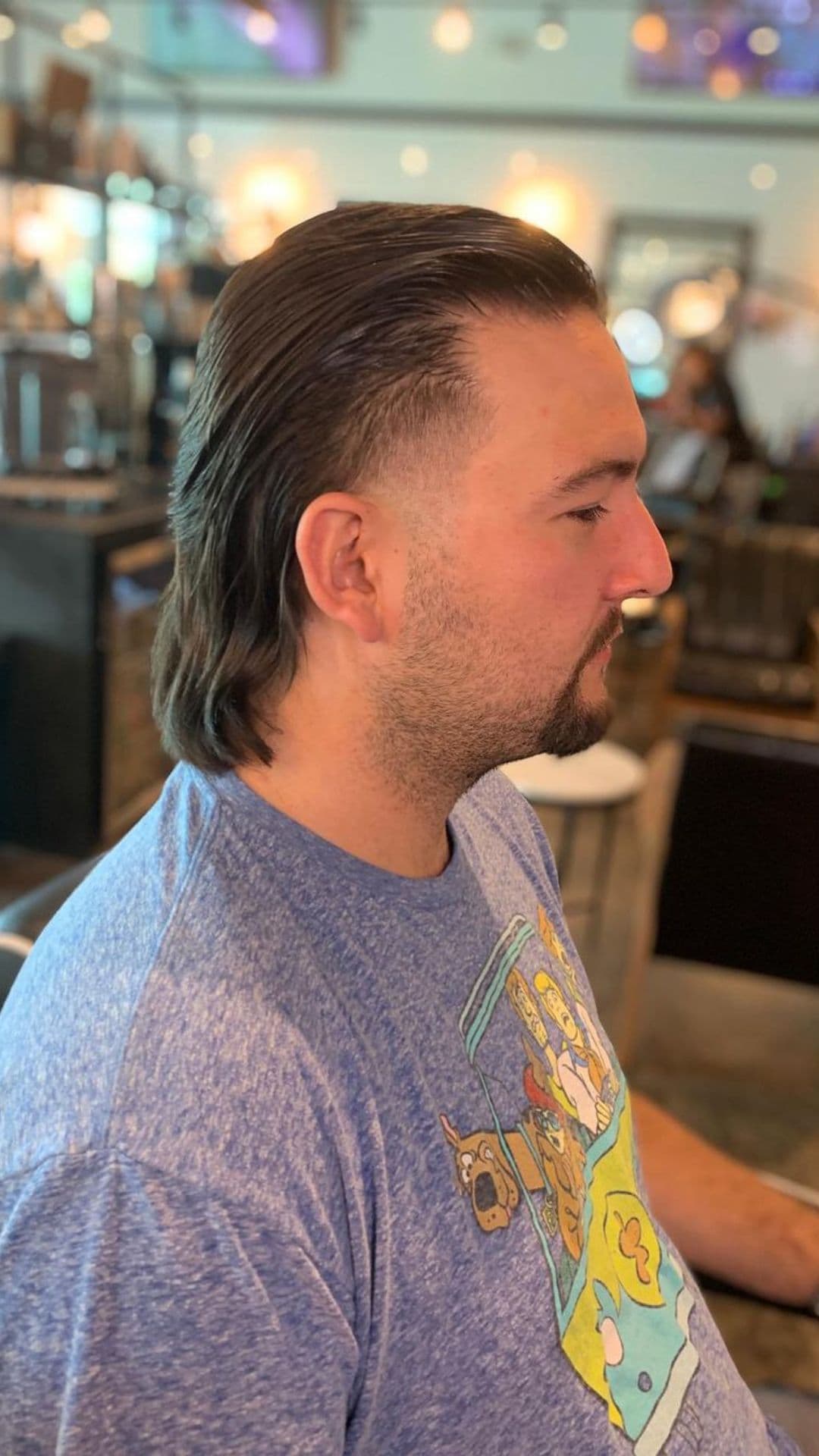A man with a slicked back mullet.