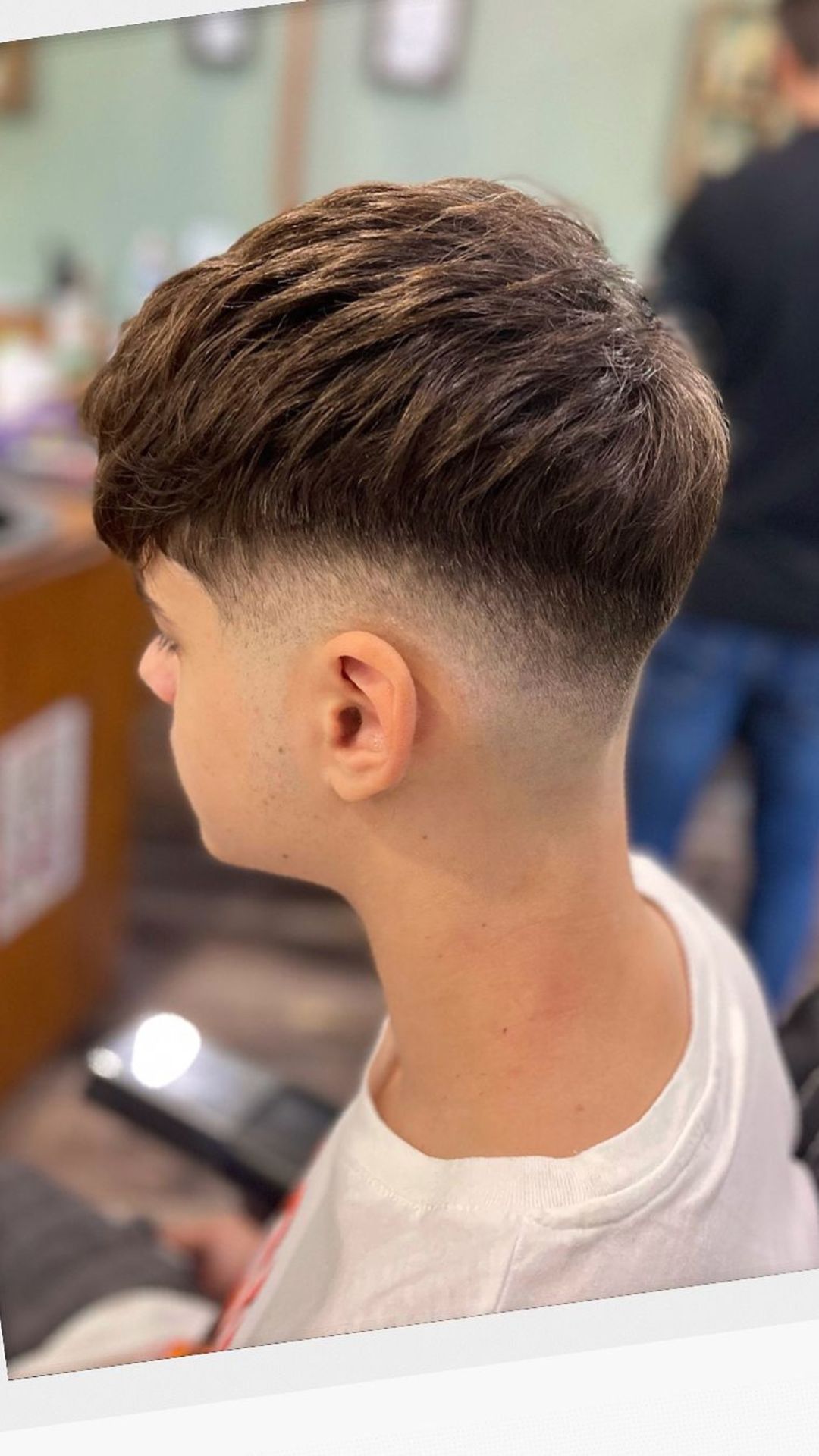 A teenage boy with a textured crop hair.
