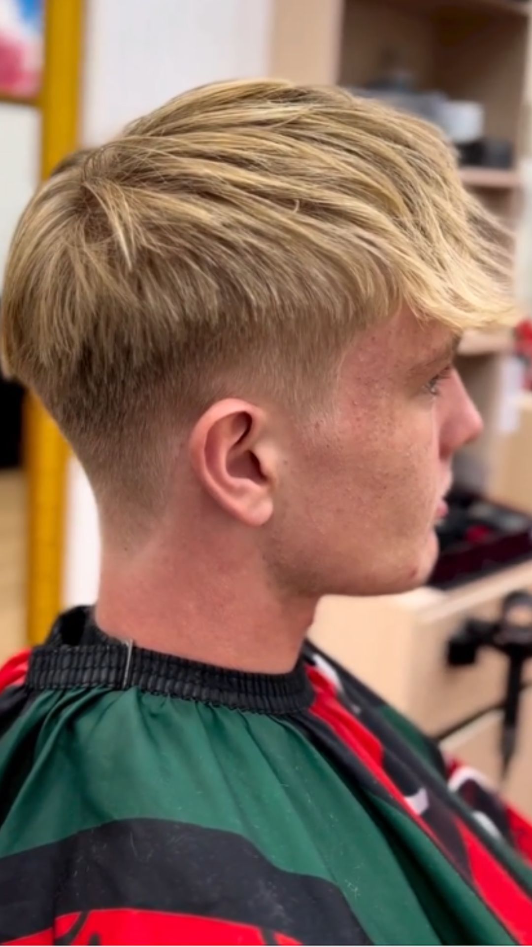 A man with a blonde textured fringe shadow fade.