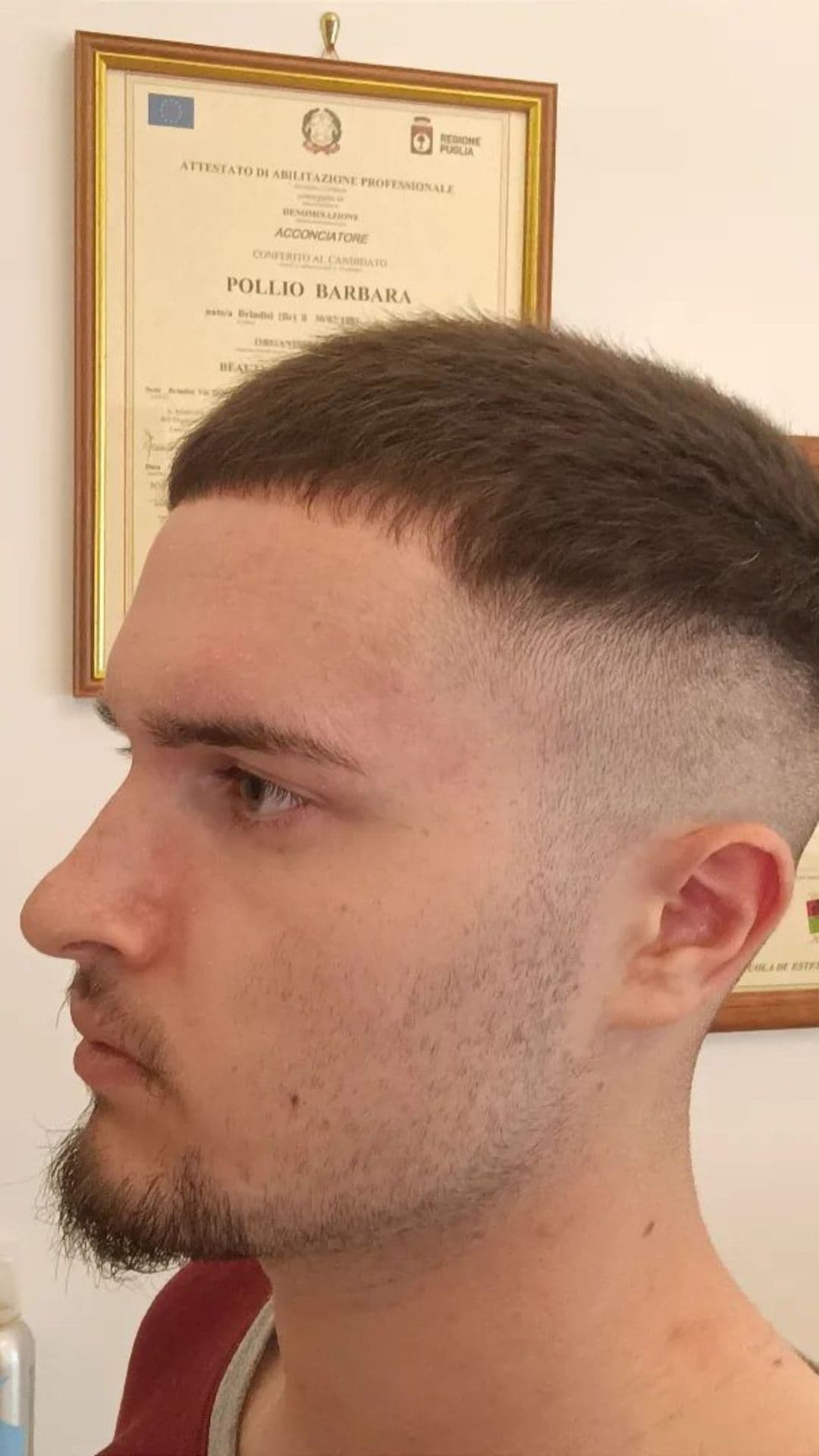 A man with a very short fade haircut.