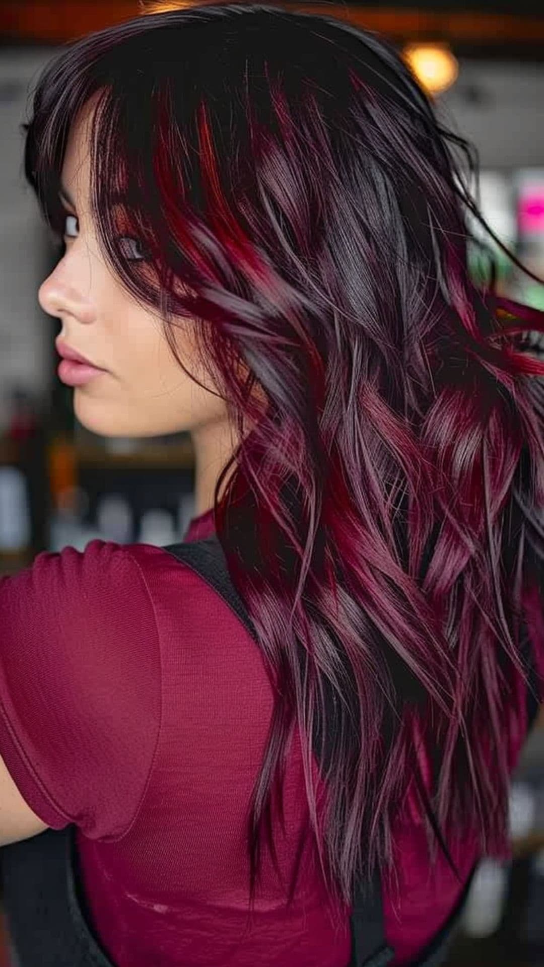 A woman modelling a bright black raspberry hair.