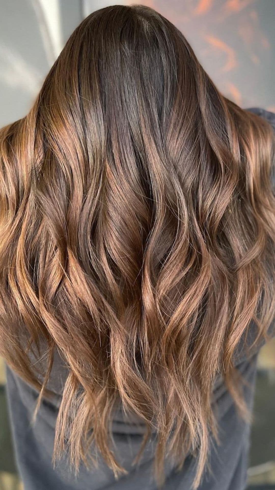 A woman modelling a brown ombre balayage highlights hair.