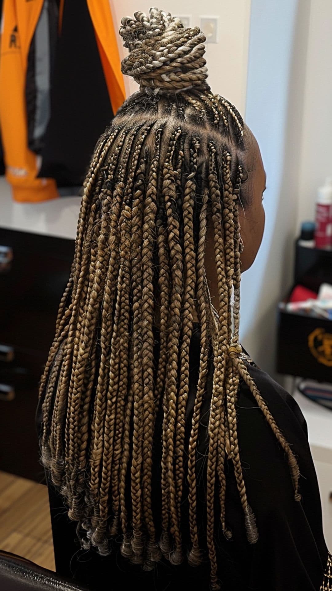 A woman modelling a half-up half-down knotless braids.