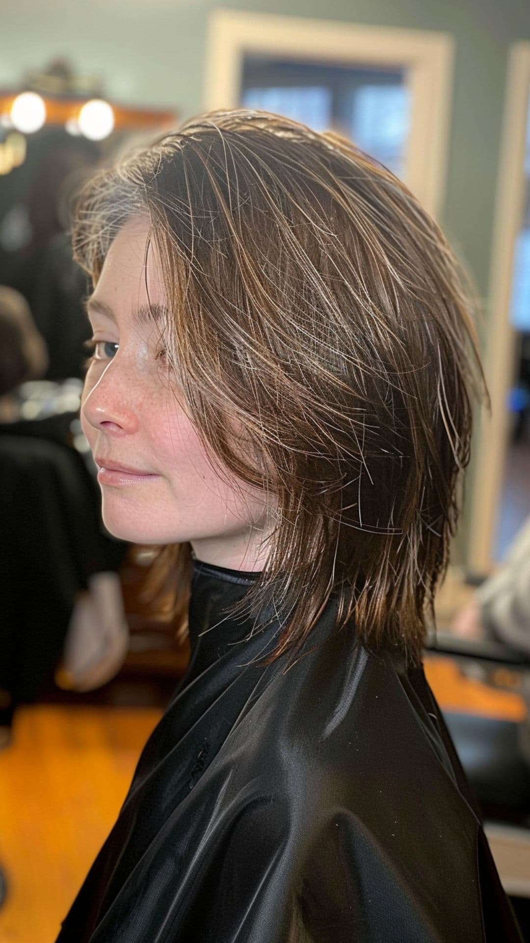 An older woman modelling a choppy layers haircut.
