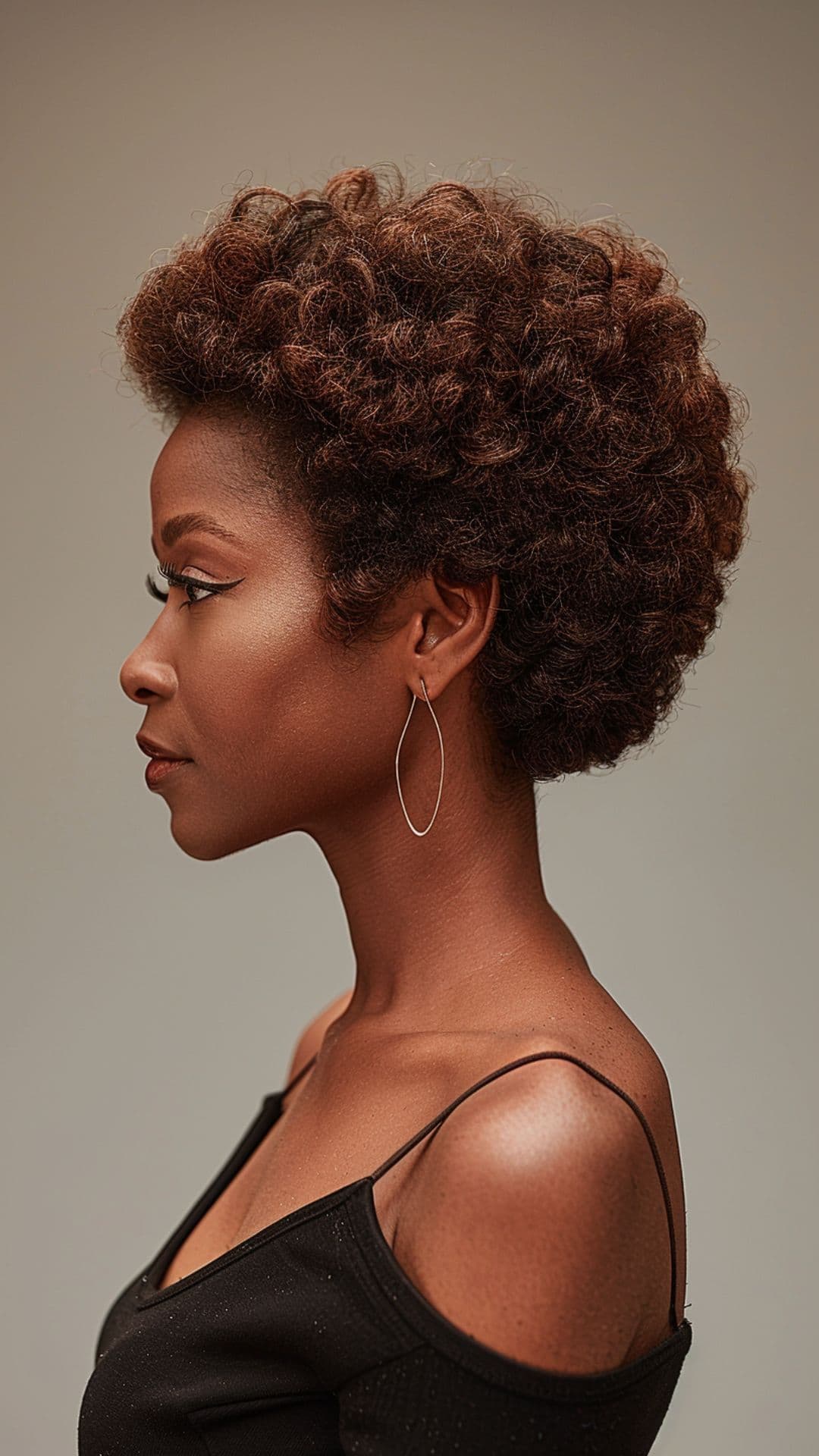 An older black woman modelling a classic short afro hairstyle.