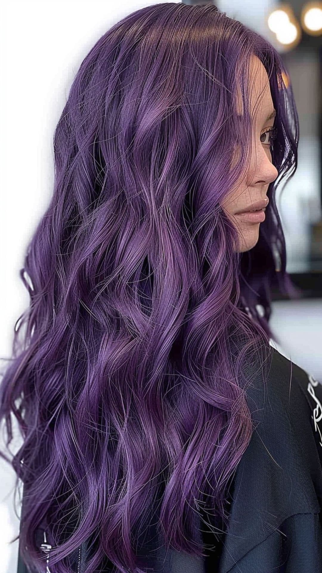 A woman modelling a deep purple hair.