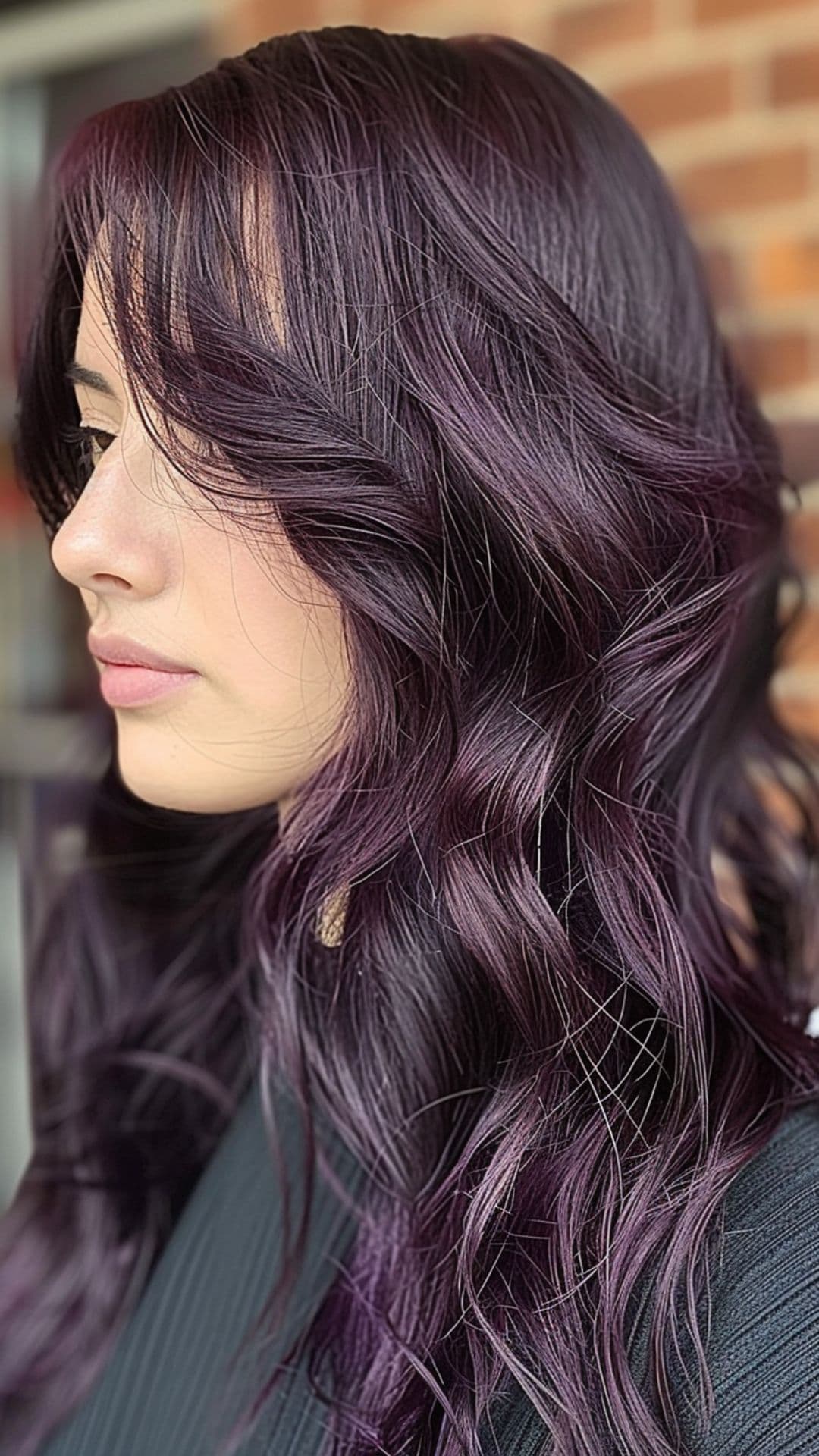 A woman modelling an eggplant hair color.
