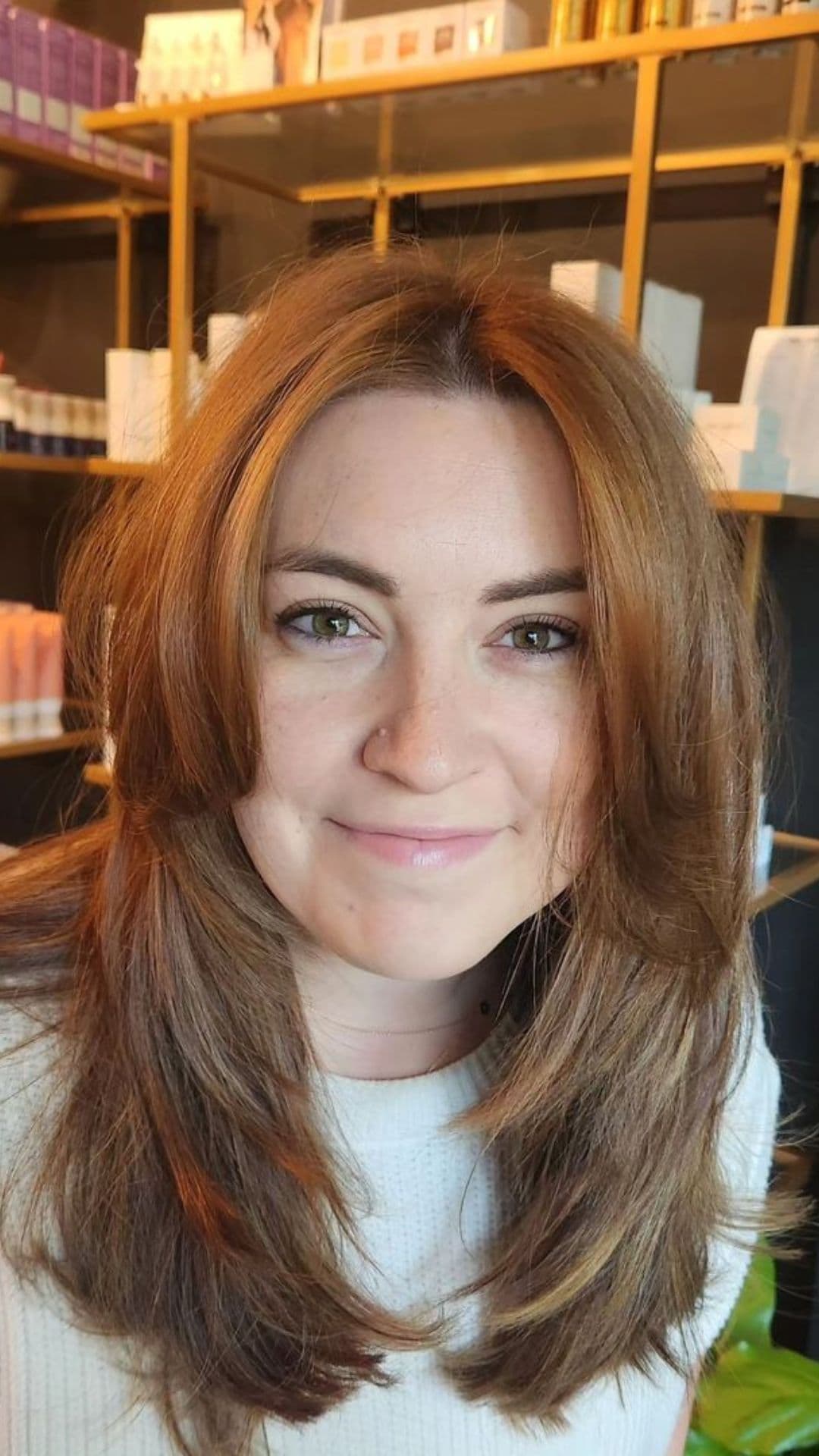 A woman modelling a face-framing style for medium hair.