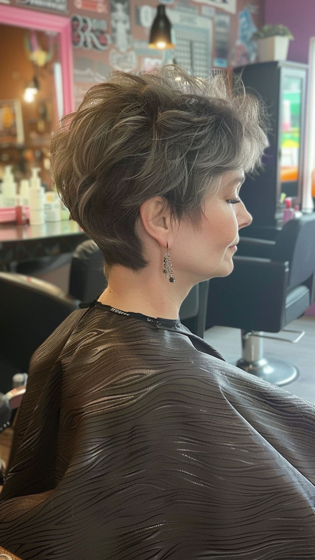 An older woman modelling a feathered pixie cut.