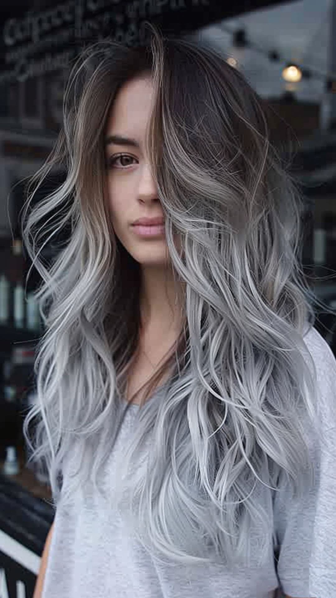 A woman modelling a frosted gray ombre hair.