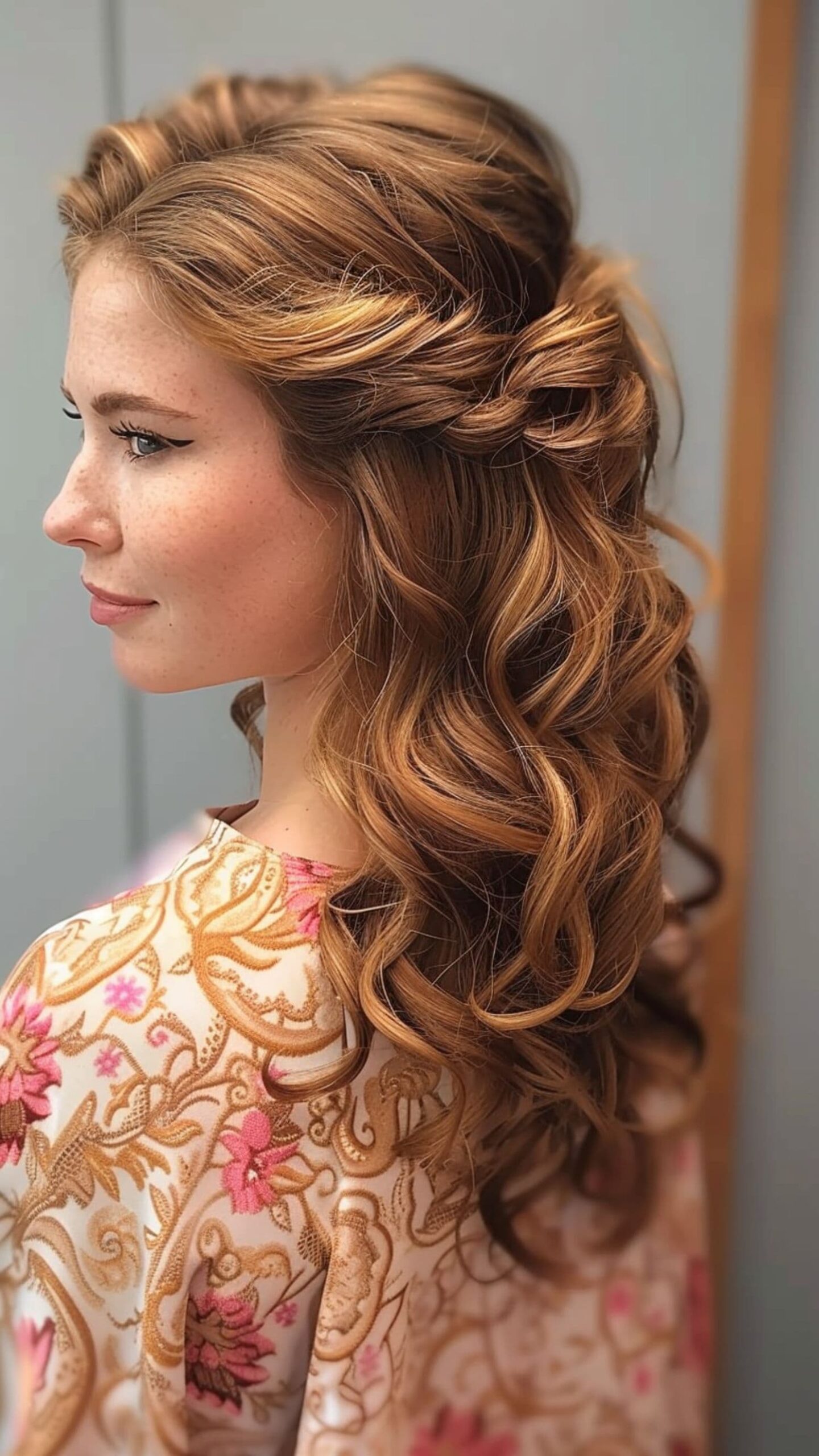 A woman modelling a half-up half-down curls hairstyle.