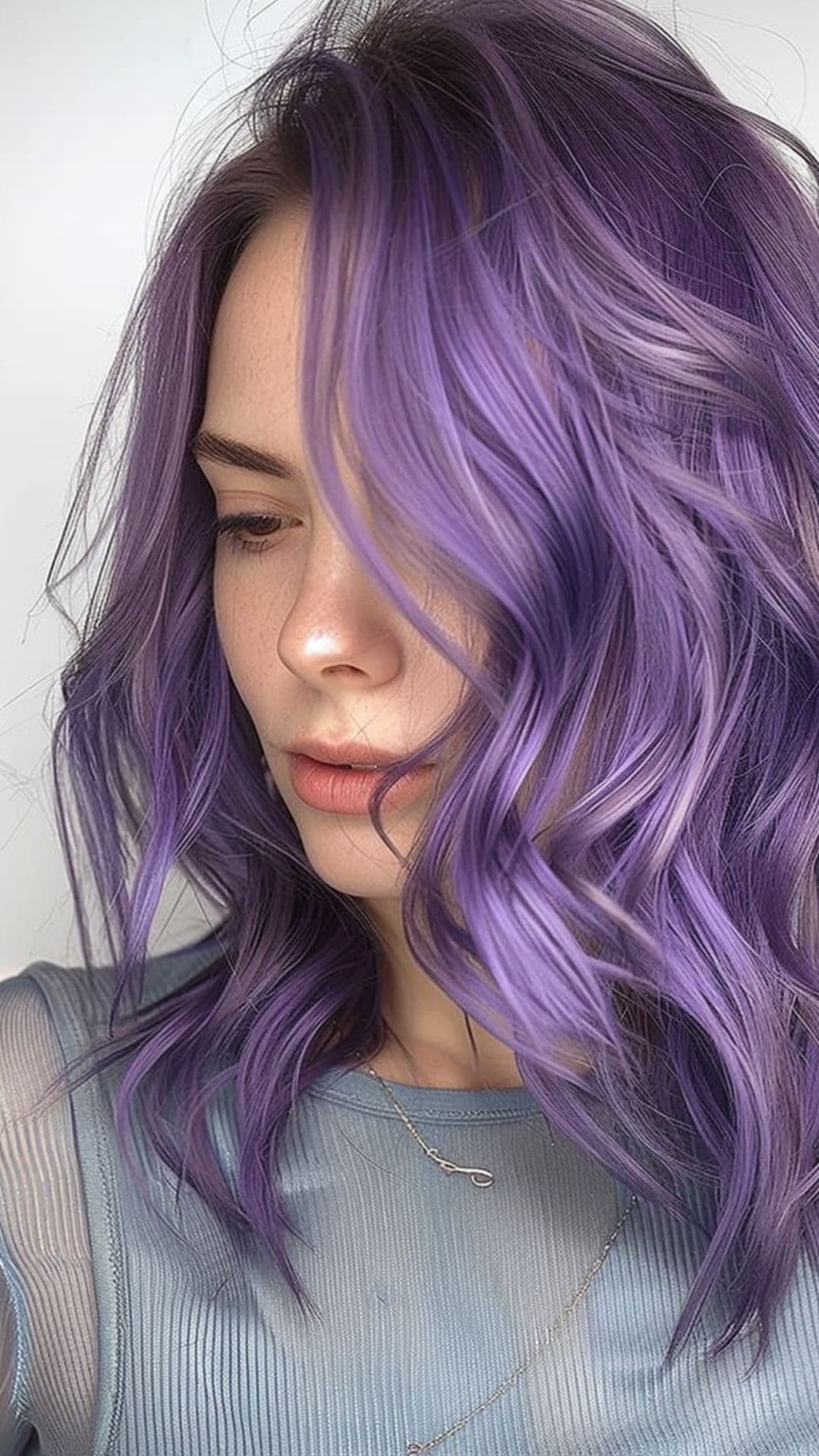 A woman modelling a lavender macaron hair color.
