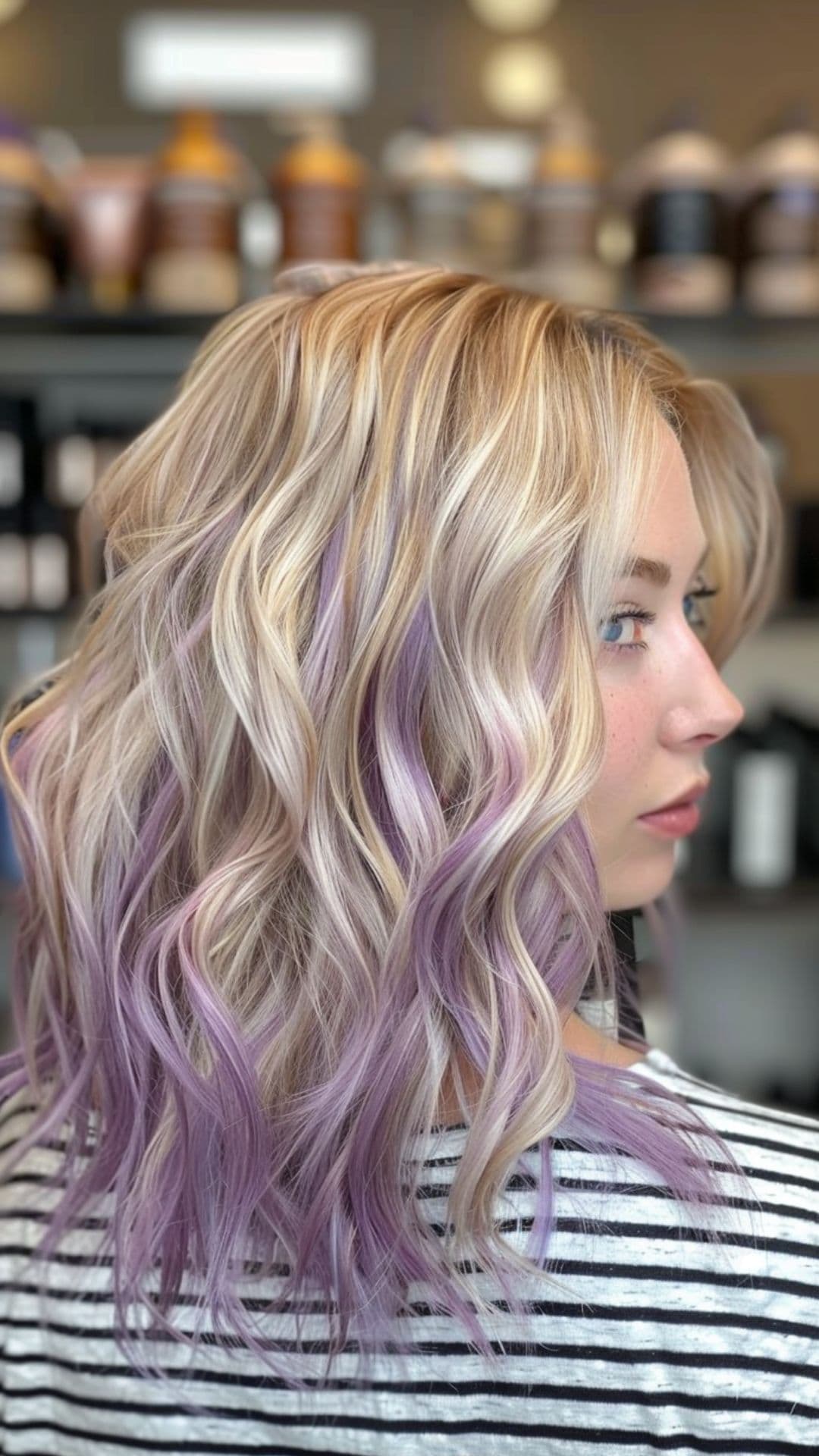 A woman modelling a lilac highlights on blonde hair.