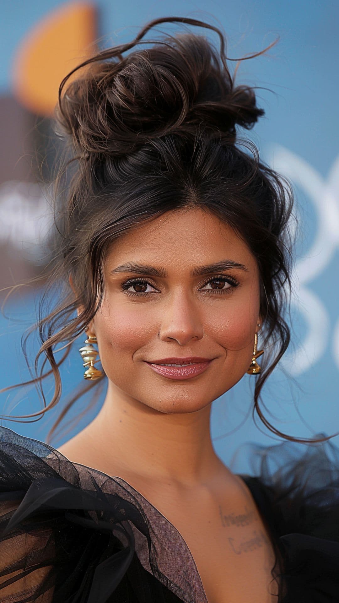A woman modelling Mindy Kaling's top knot hair.