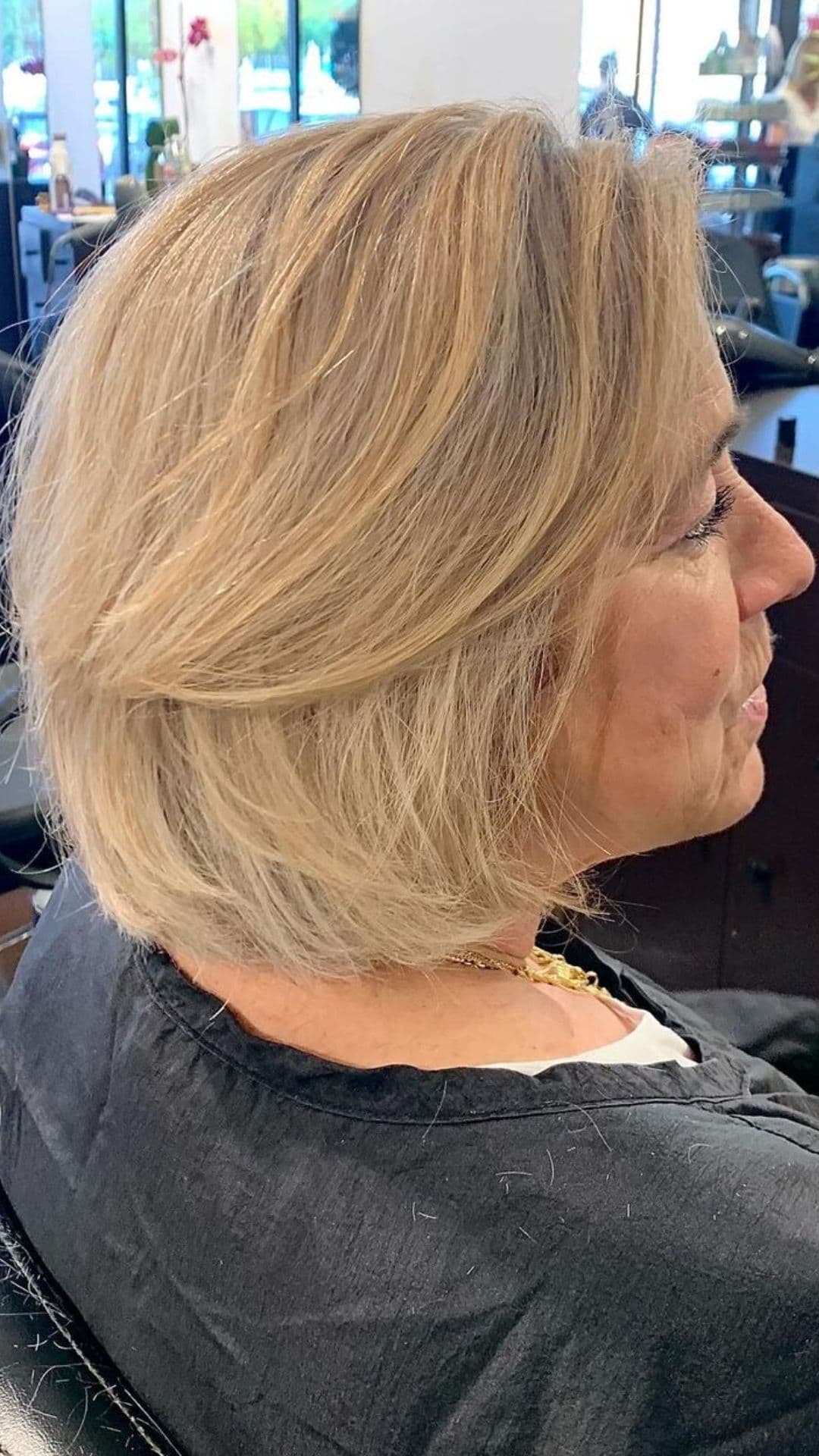 An older woman modelling a shaggy blonde bob haircut.